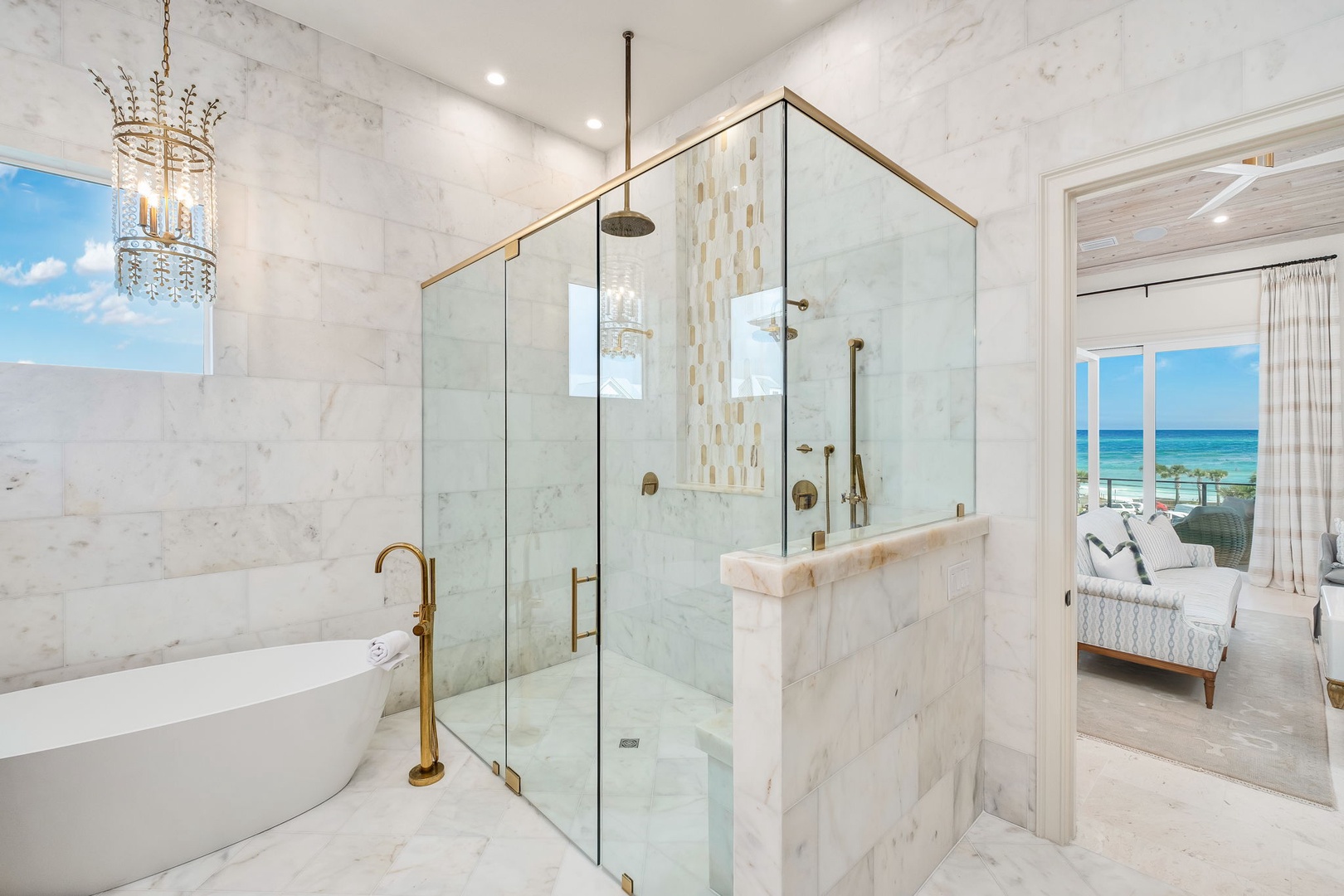 Luxurious marble bathroom with a spa-like shower, soaking tub, and stunning ocean views—your private sanctuary for relaxation and rejuvenation awaits.