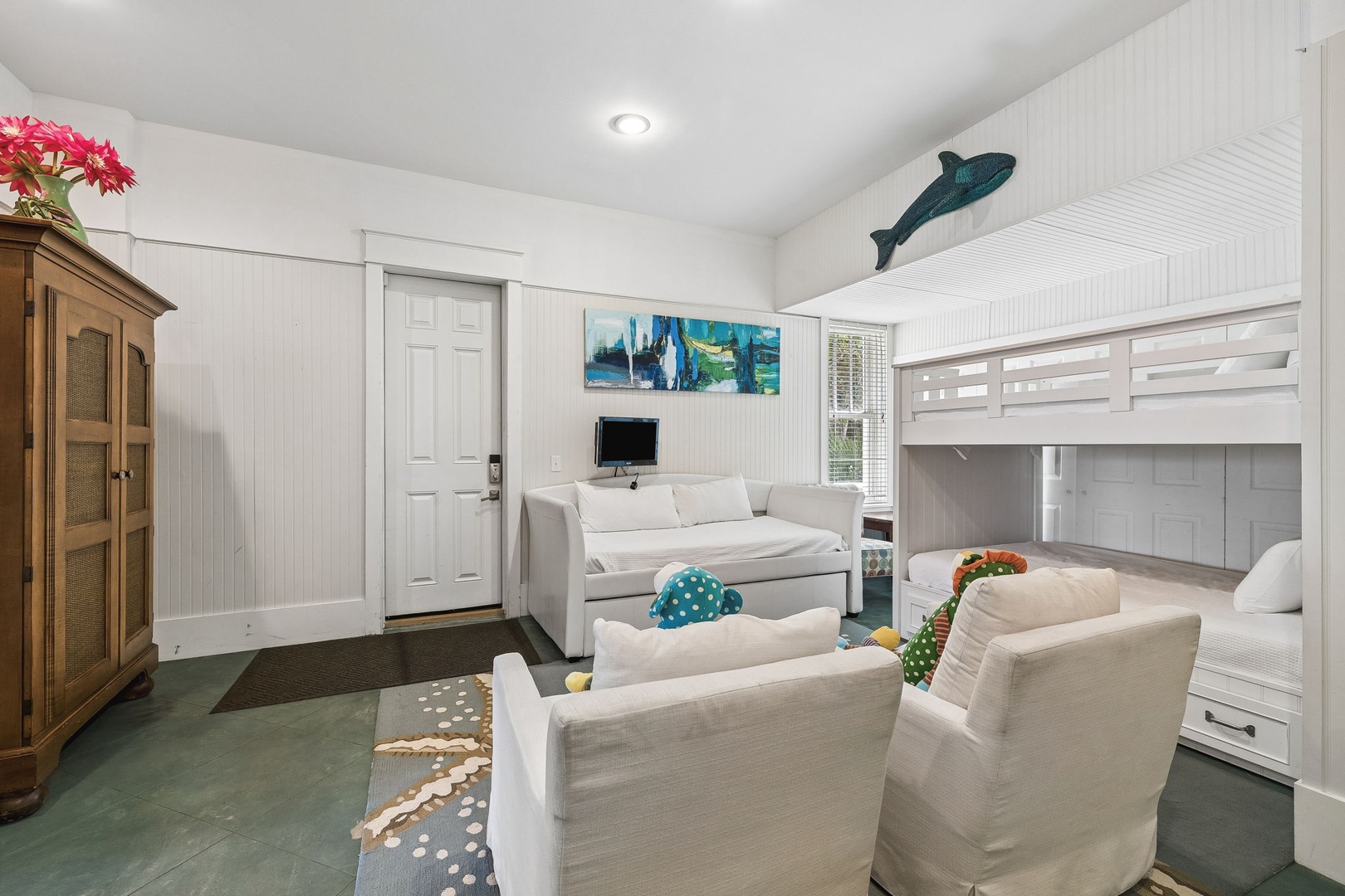 Unwind in your cozy family-friendly living space with bunk beds and a daybed, perfect for the kids. Bright natural light and cheerful coastal touches create a welcoming retreat after your beach adventures.