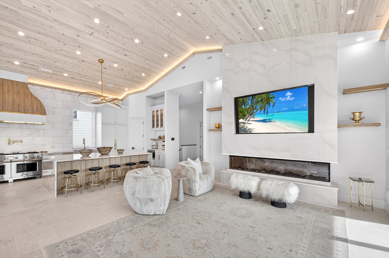 Unwind in this stunning open-concept space where luxurious comfort meets modern design, featuring a cozy fireplace and chef's kitchen.