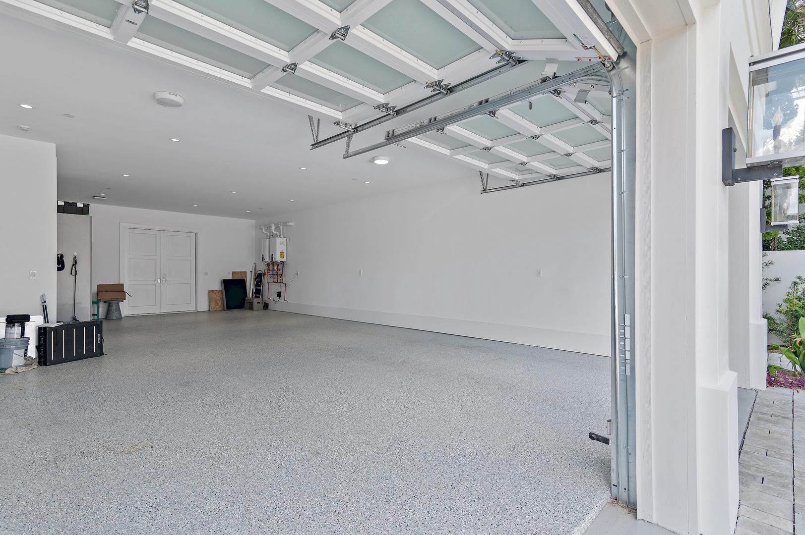 A spacious garage with modern finishes and clean flooring provides secure parking and extra storage for your convenience during your stay.
