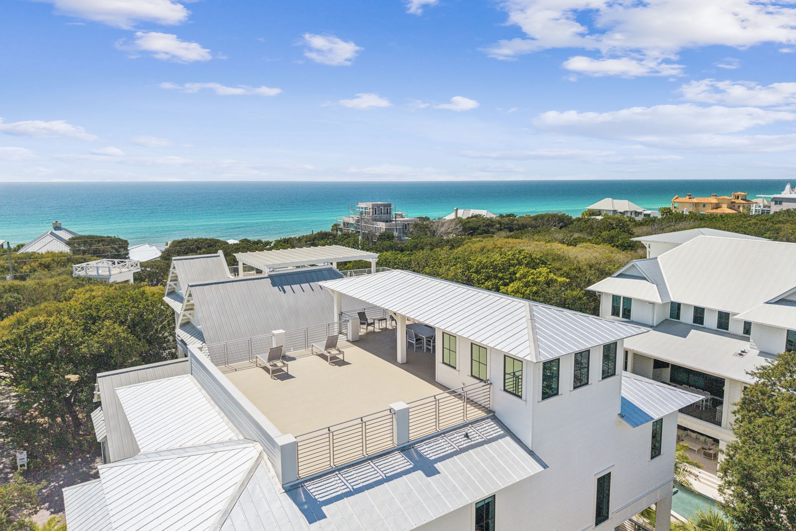 Modern coastal property with stunning sea views and rooftop terrace just steps from pristine turquoise waters.