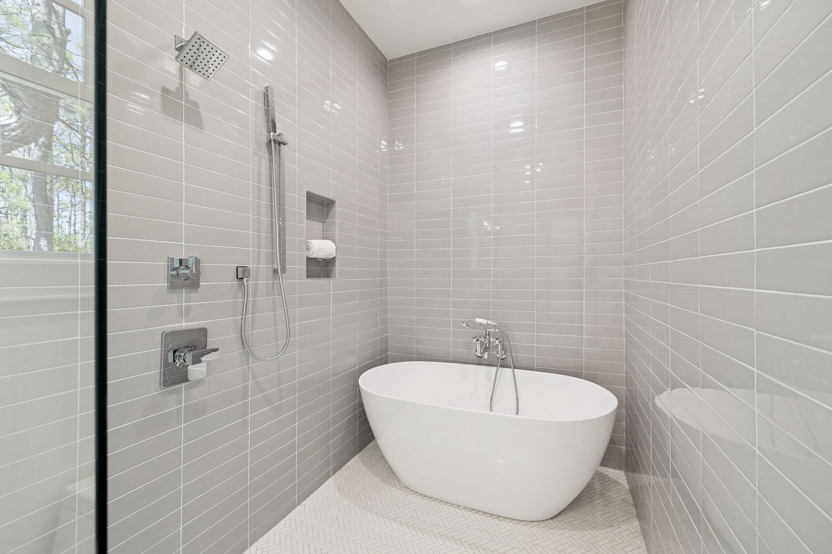 Sink into pure relaxation in your spa-like bathroom, featuring a luxurious soaking tub and rainfall shower with elegant tile work.