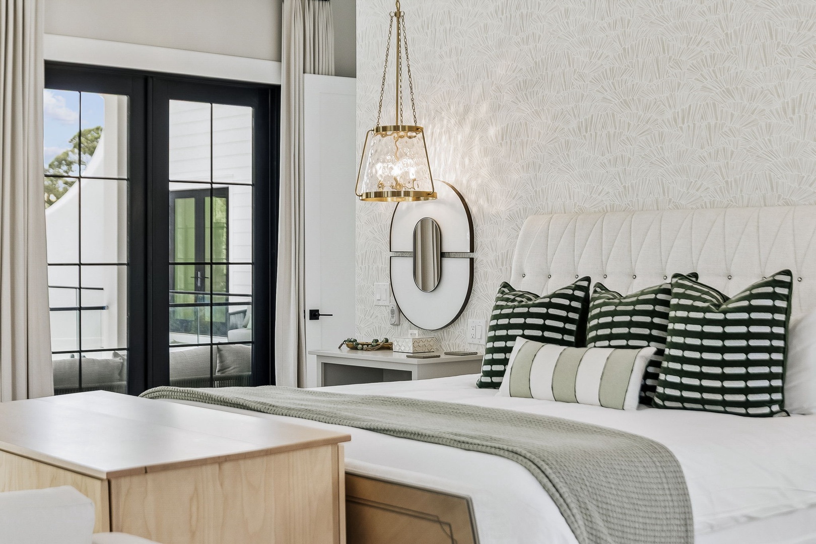 Slip into crisp linens and let natural light fill your serene retreat. The luxe upholstered headboard and chic décor set a sophisticated, restful mood for your stay.