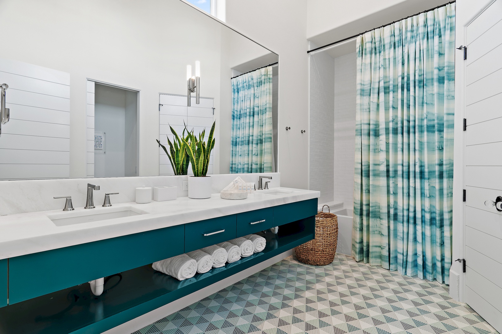Step into your spa-like bathroom, where coastal charm meets modern comfort. Fresh towels await, and soft natural light fills the space—your perfect retreat after a day exploring.