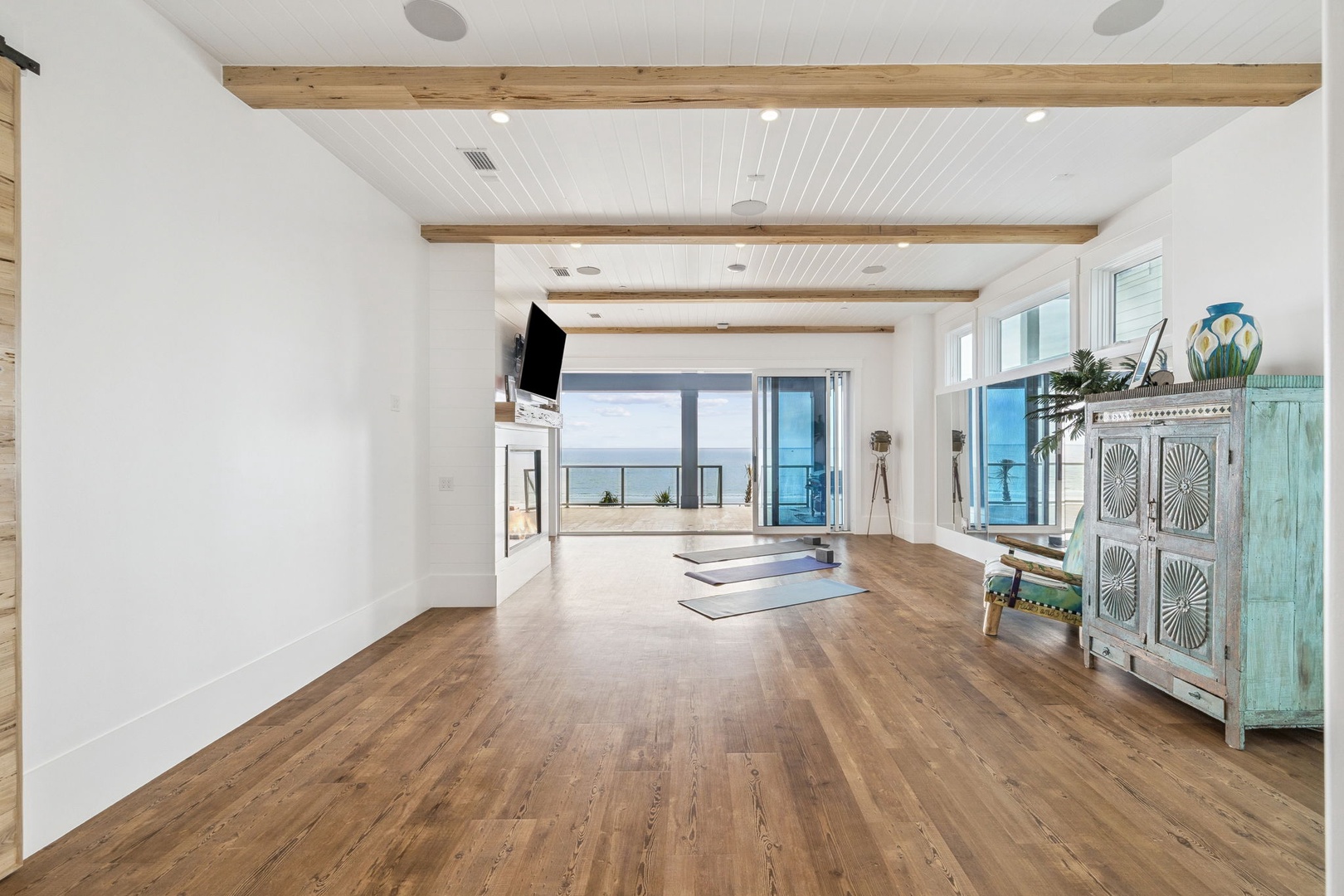 Your private wellness sanctuary awaits with ocean views, exposed beams, and space for yoga or meditation.