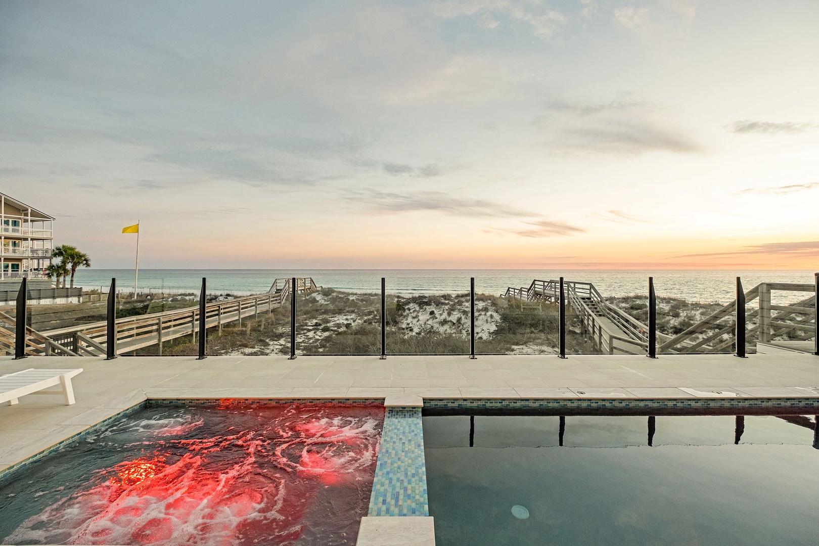 Beachfront pool and hot tub with stunning sunset views over the Gulf, complete with private beach access.