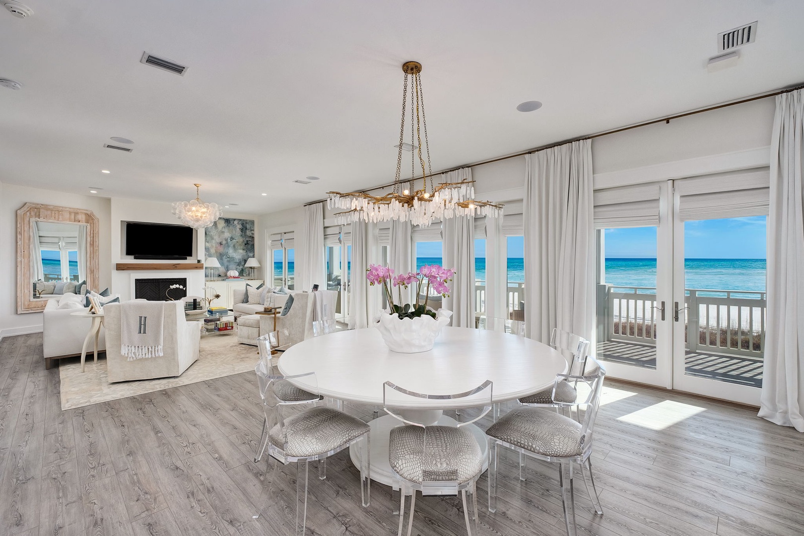 Step into your bright coastal retreat, where elegant dining and relaxing living spaces open to breathtaking ocean views. Sunlight streams through floor-to-ceiling windows, inviting you to unwind in style by the sea.