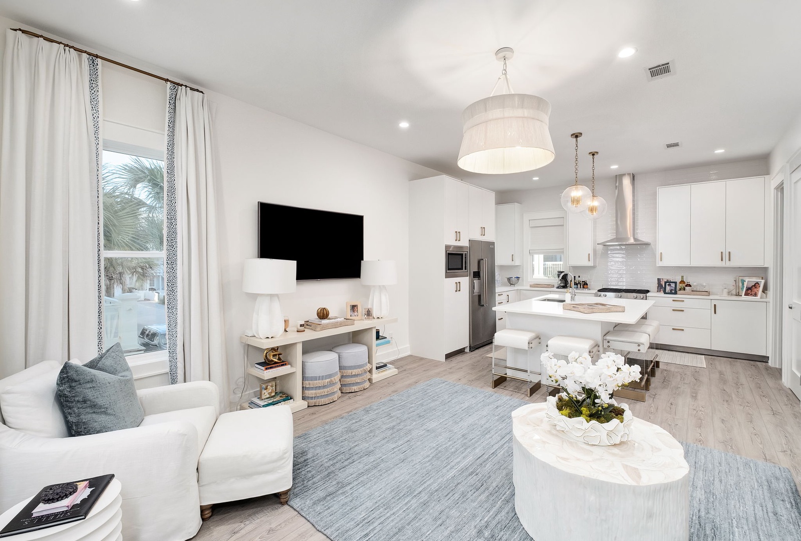 Unwind in this bright, open living space where coastal elegance meets modern comfort. Your fully-equipped kitchen flows into a cozy lounge with plush seating and stylish coastal touches.