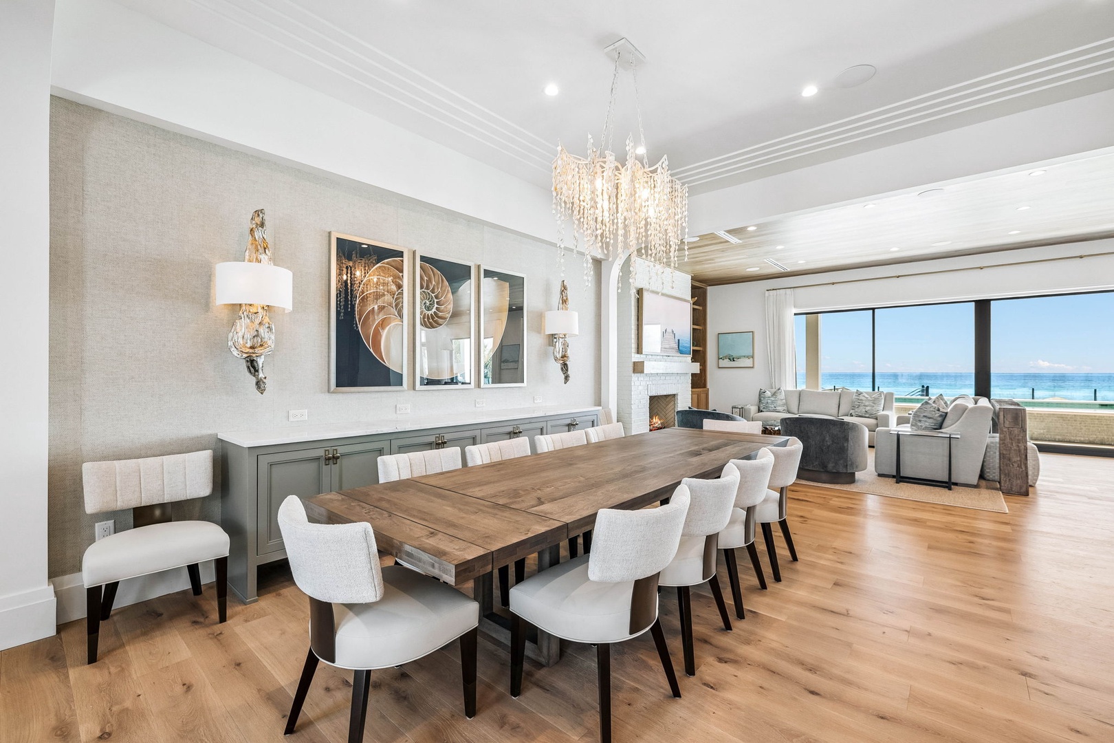 Gather around the table with ocean breezes and endless blue visible just beyond. Elegant details and a statement chandelier set the scene for memorable meals together.
