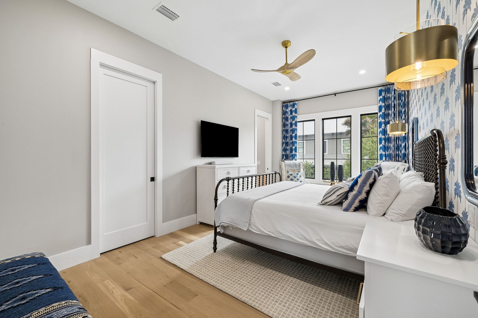 Unwind in this serene bedroom where natural light pours through large windows, highlighting crisp linens and coastal-inspired décor. Your peaceful retreat awaits with modern comforts and stylish touches throughout.