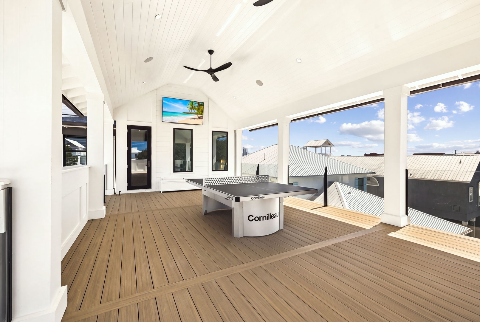 Step into your private rooftop retreat with a stunning ping-pong table ready for friendly matches. Floor-to-ceiling windows flood the space with natural light while offering breezy views of the neighborhood skyline.