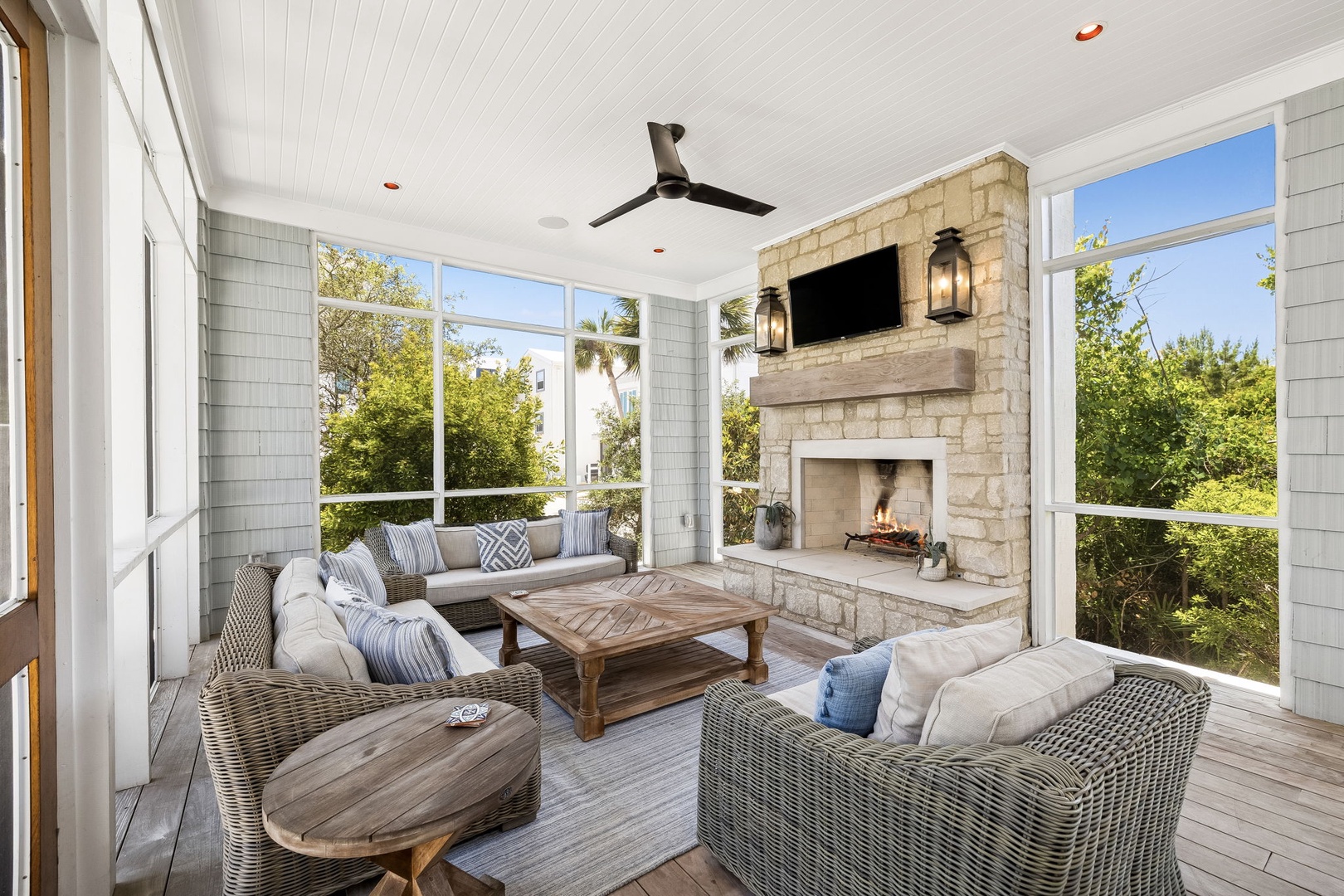 Unwind in your private screened porch with plush seating, ceiling fan, fireplace, and garden views—your perfect retreat for morning coffee or evening relaxation.