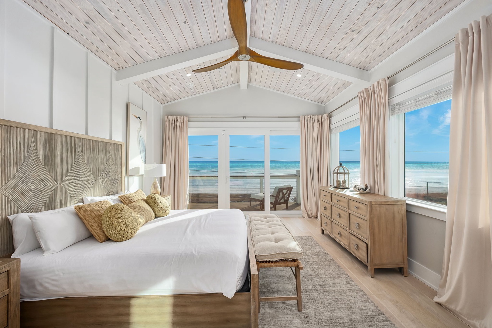 Wake up to endless ocean views in your serene coastal bedroom, where whitewashed beams and soft linens create the perfect beachside retreat.