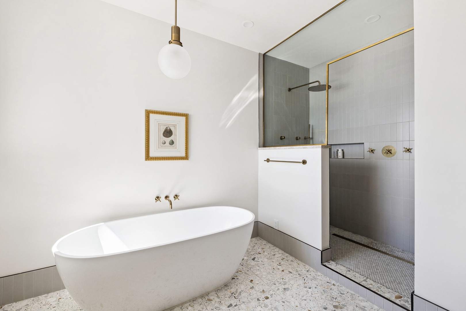 Unwind in your luxurious bathroom featuring a dreamy soaking tub and rainfall shower, where elegant brass fixtures meet modern sophistication.