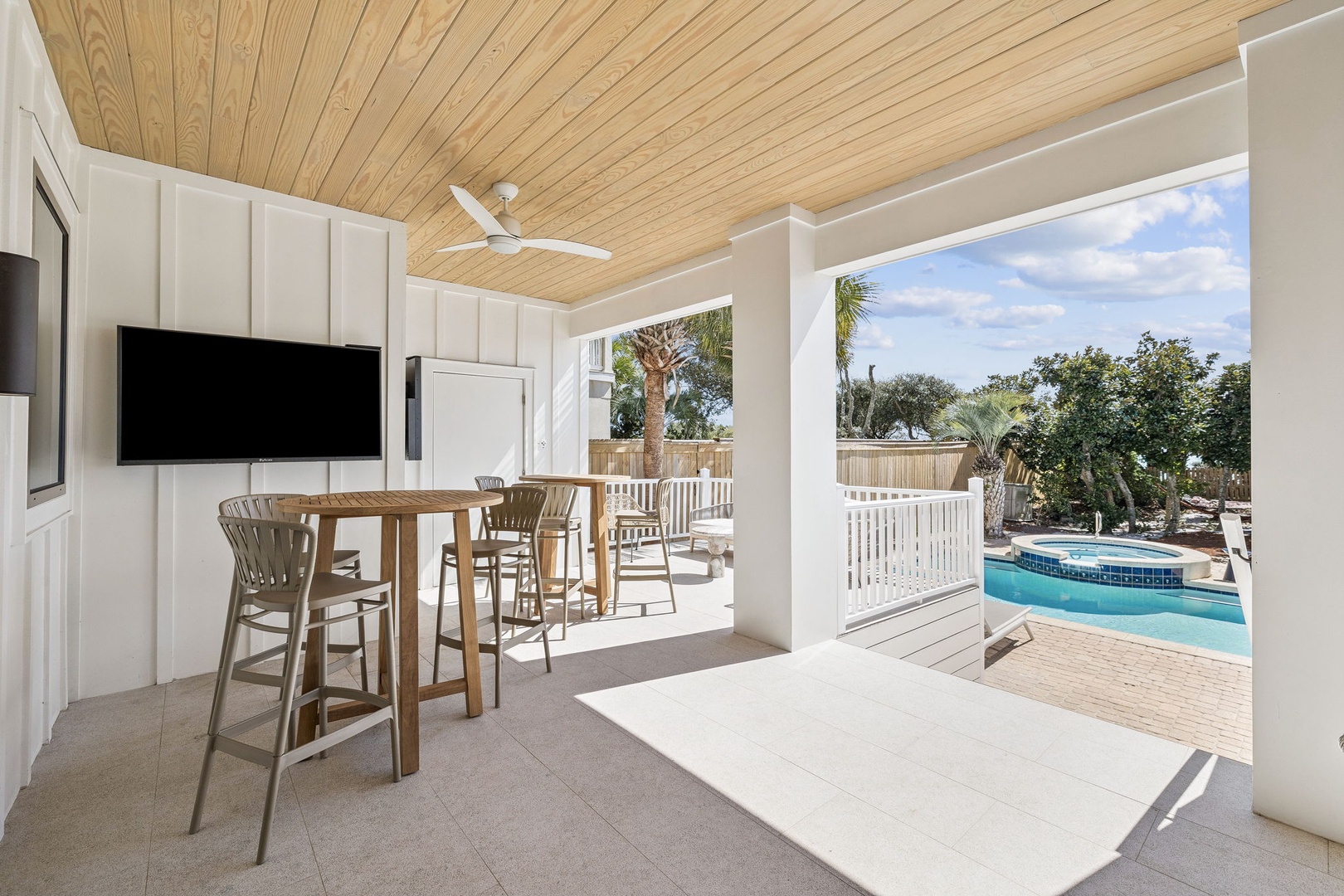 Relax at your private poolside bar with stunning water views and tropical breezes flowing through this elegant covered terrace.