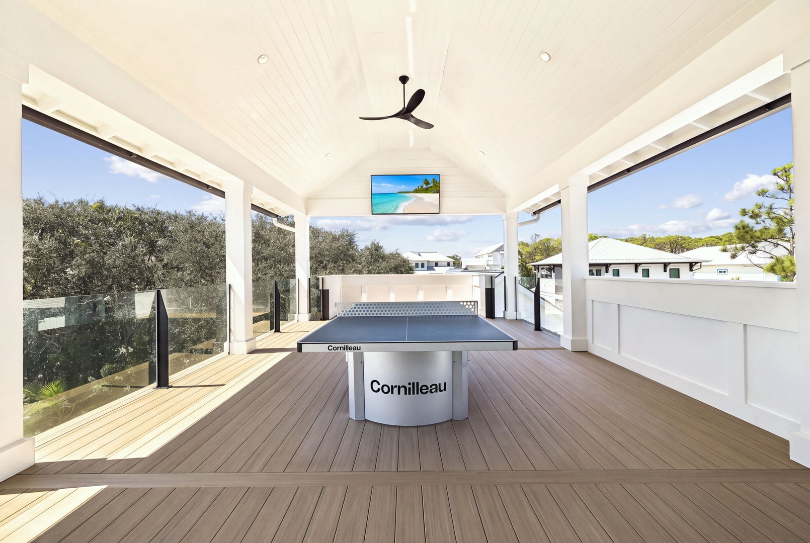 Your private game pavilion awaits with a professional ping-pong table, soaring ceilings, and gentle breezes flowing through open walls that frame the surrounding greenery.