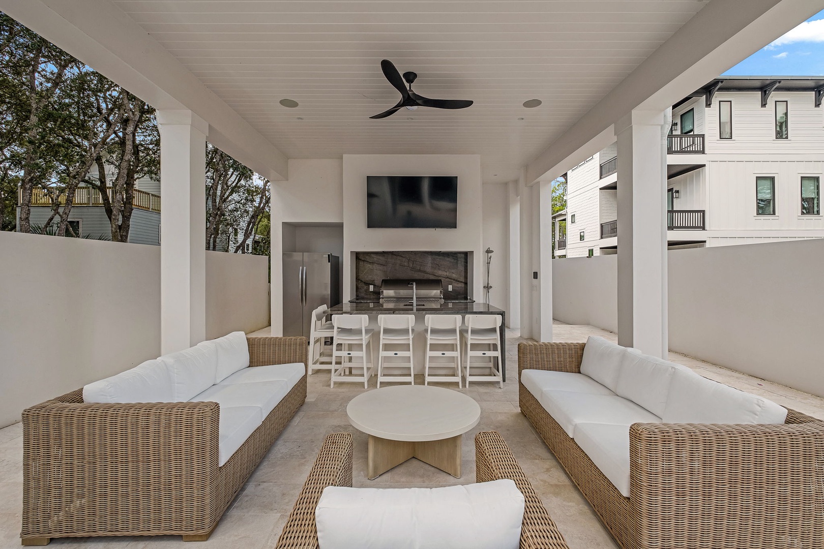 Your private outdoor oasis awaits, where plush seating and a sleek dining setup create the perfect space to relax or gather with friends beneath the cool shade.