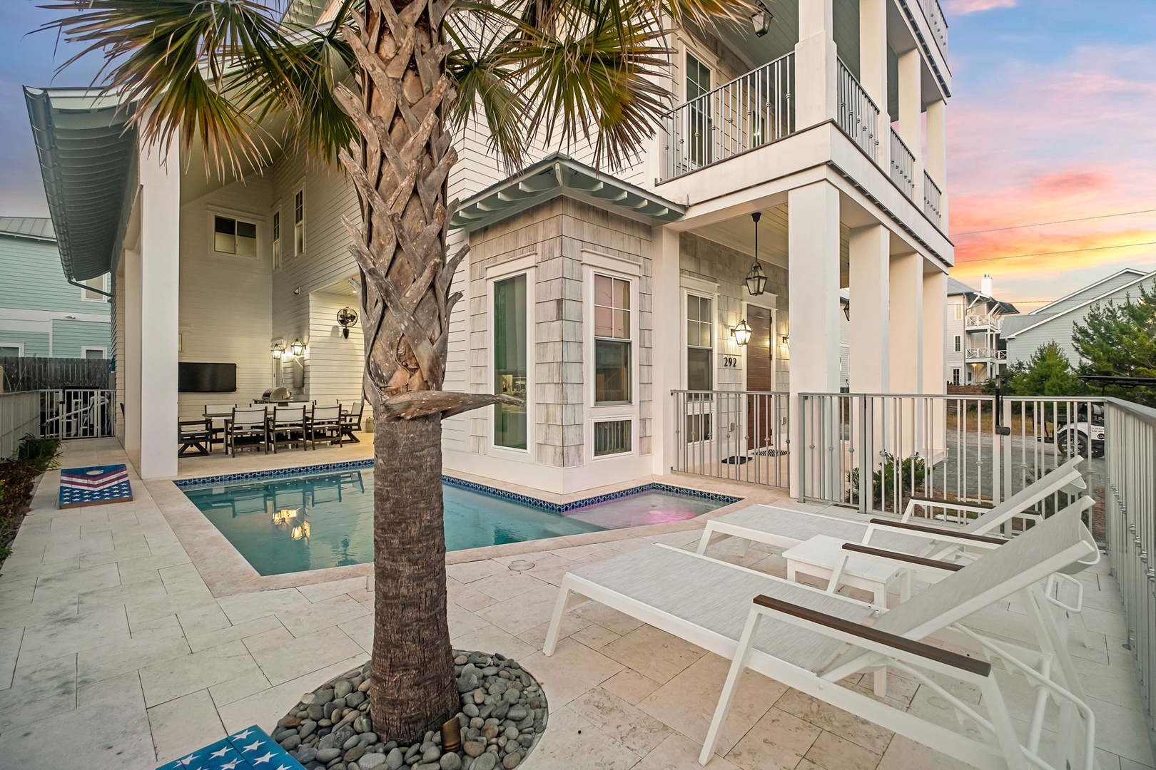 Stunning coastal retreat with private pool, palm-lined deck, and dreamy sunset views creating the perfect backdrop for your beach getaway.