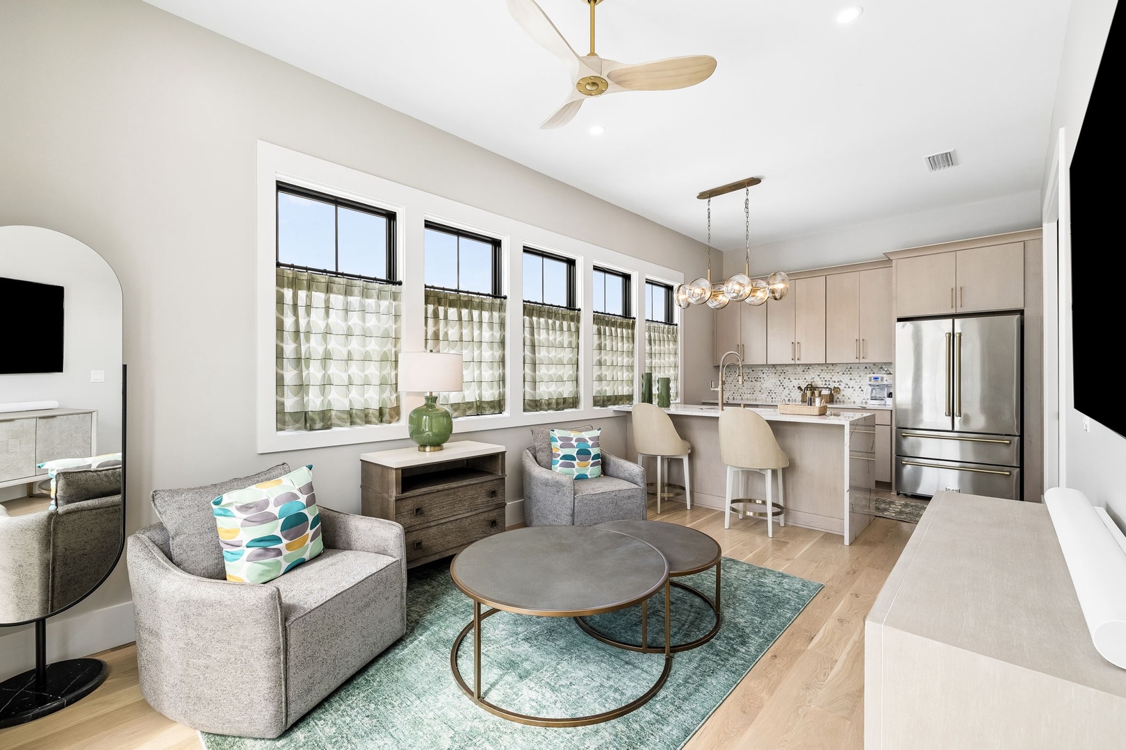 Settle into your bright, airy retreat with modern comforts. This open-plan space flows from cozy seating to a fully-equipped kitchen, perfect for relaxing and preparing meals in style.