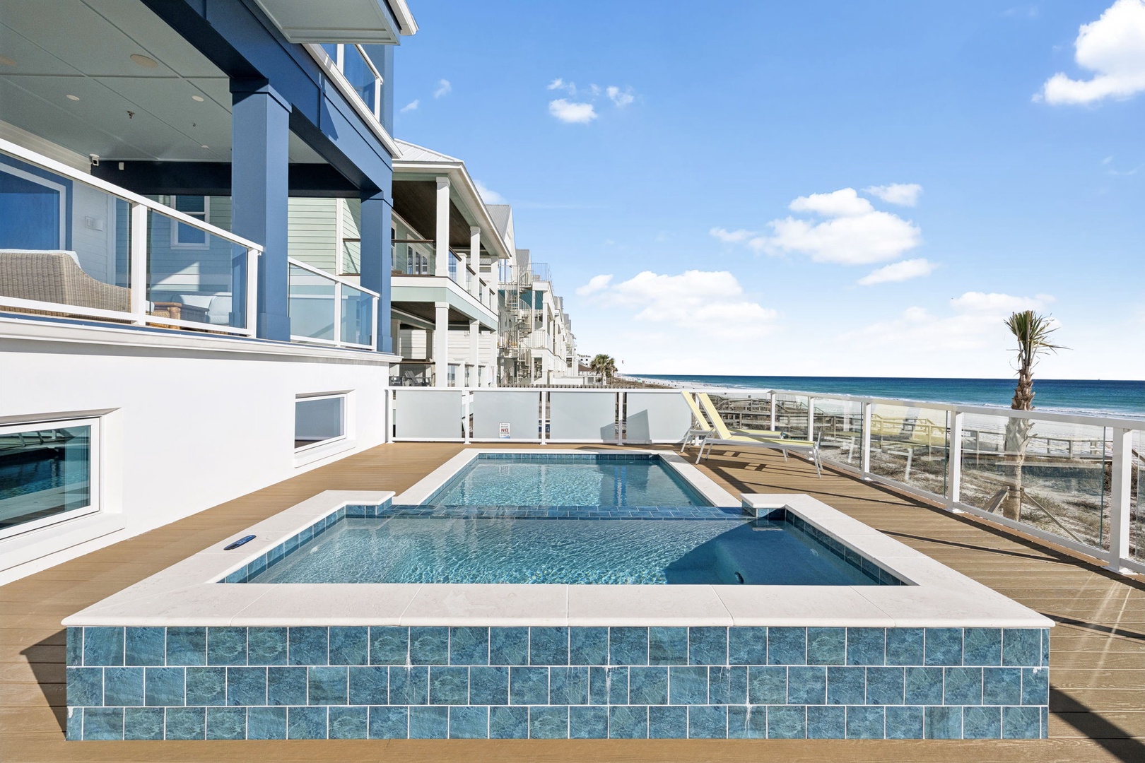 Modern beachfront property featuring a pristine swimming pool with direct ocean views and contemporary architecture.