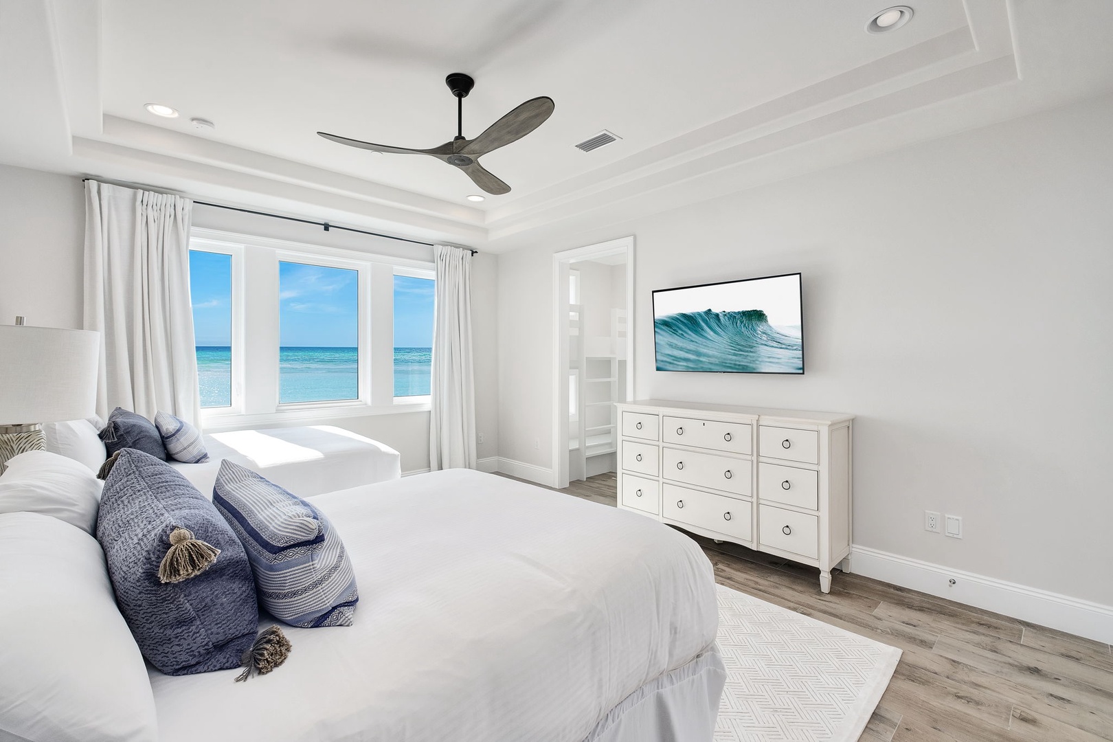 Your coastal bedroom sanctuary features ocean views and peaceful blues, where you'll drift to sleep with sea breezes.