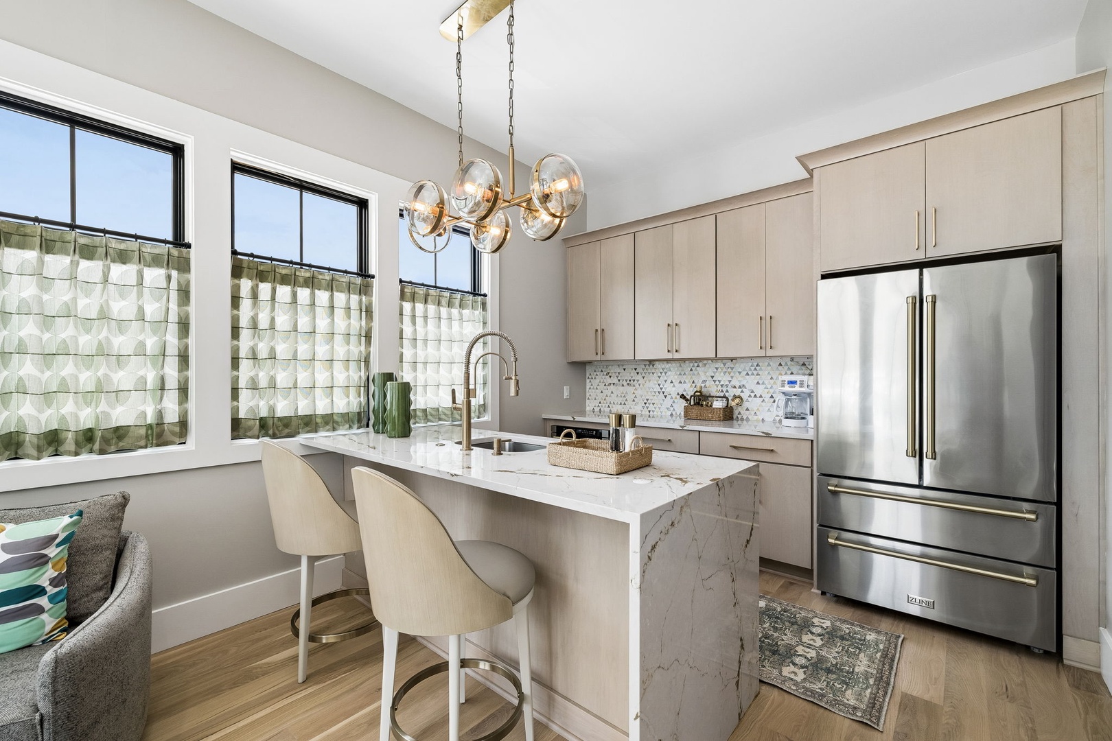 Your fully equipped kitchen invites you to prepare meals in style, with sleek countertops, stainless steel appliances, and a bright island where you can gather for casual dining.