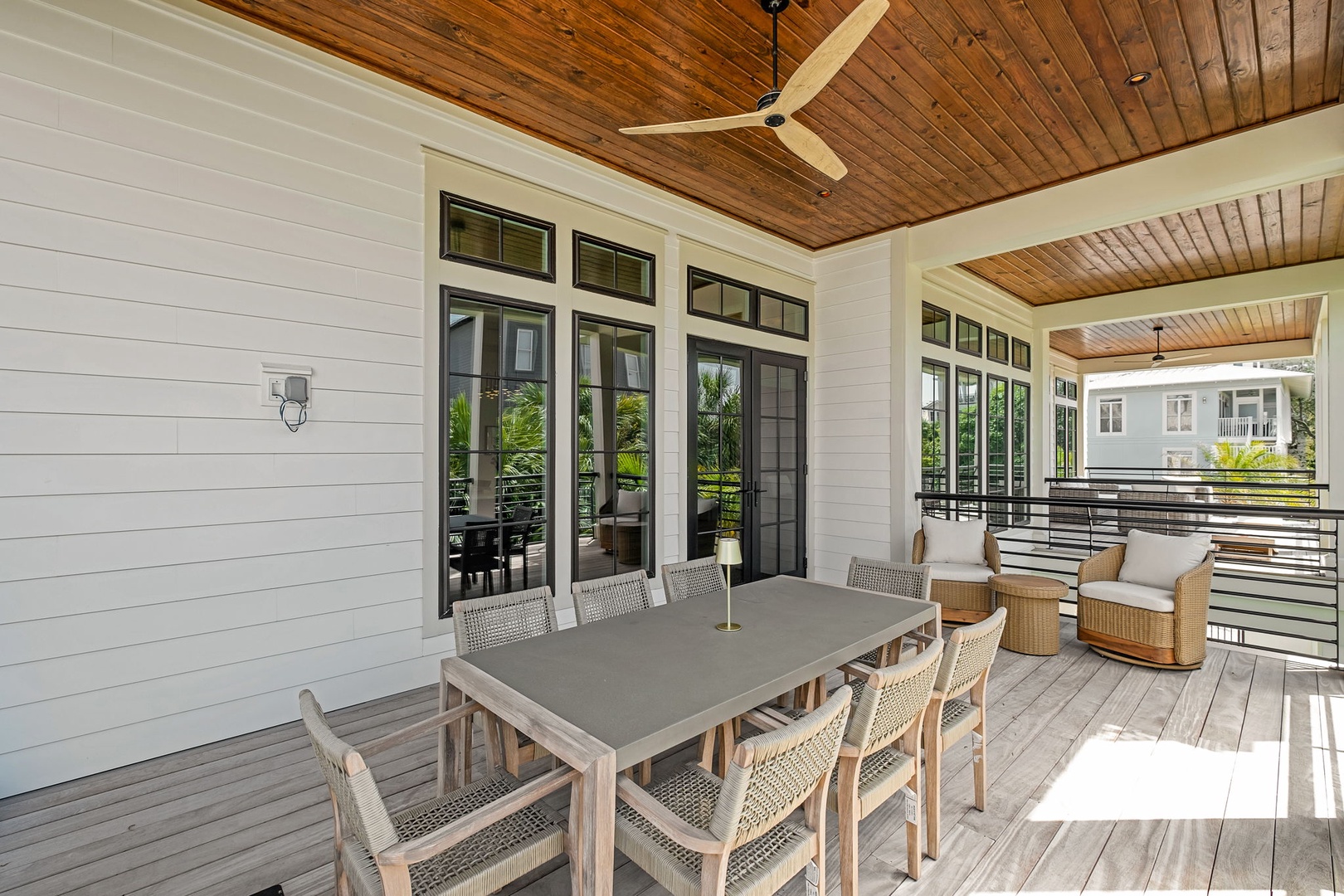 Your covered terrace offers stylish outdoor dining with modern furnishings and ceiling fans for comfort during leisurely meals.