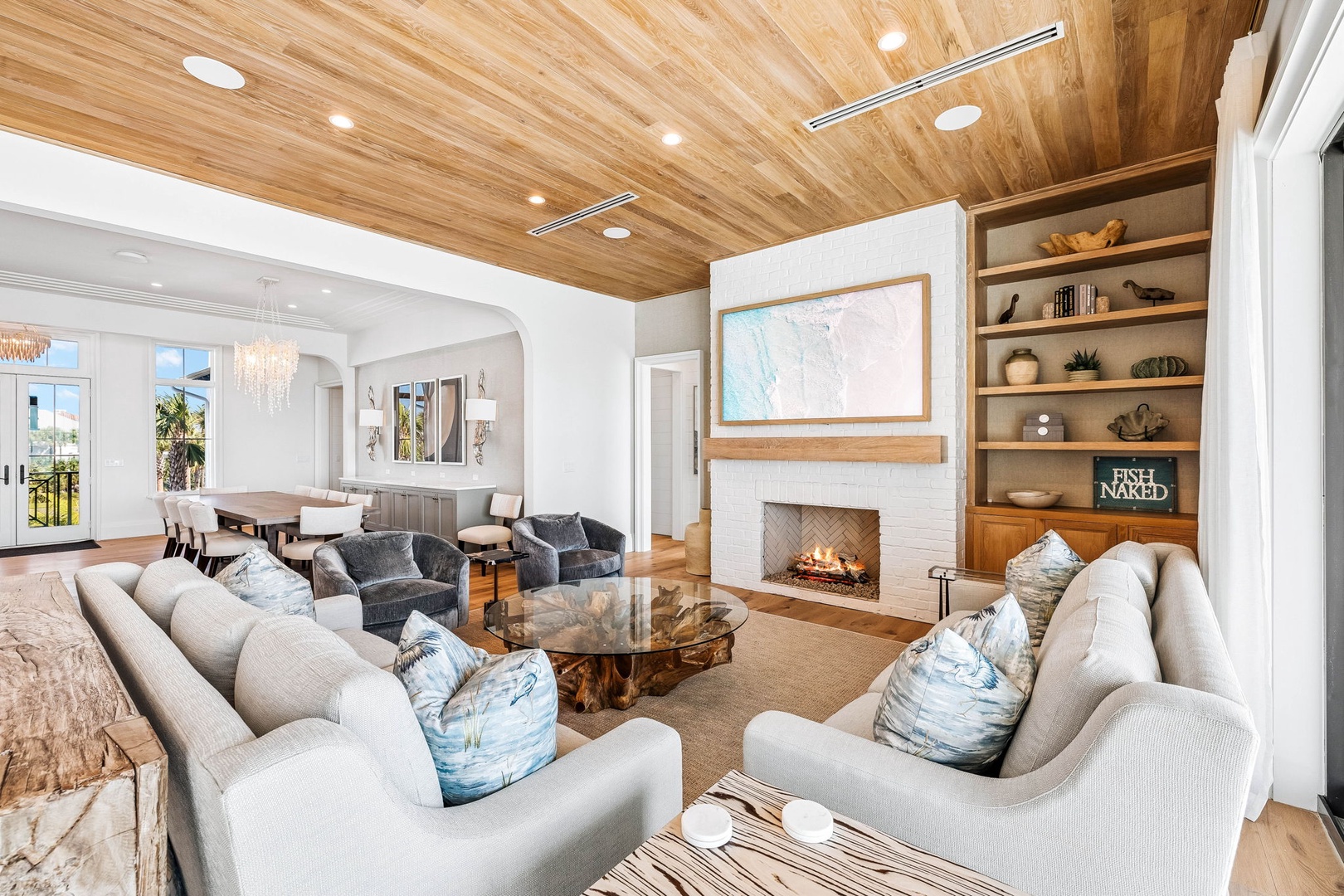 Sink into plush sofas by the fireplace, where warm wood tones and coastal blues create your perfect spot to unwind. The open layout invites you to relax, gather, and make yourself completely at home.
