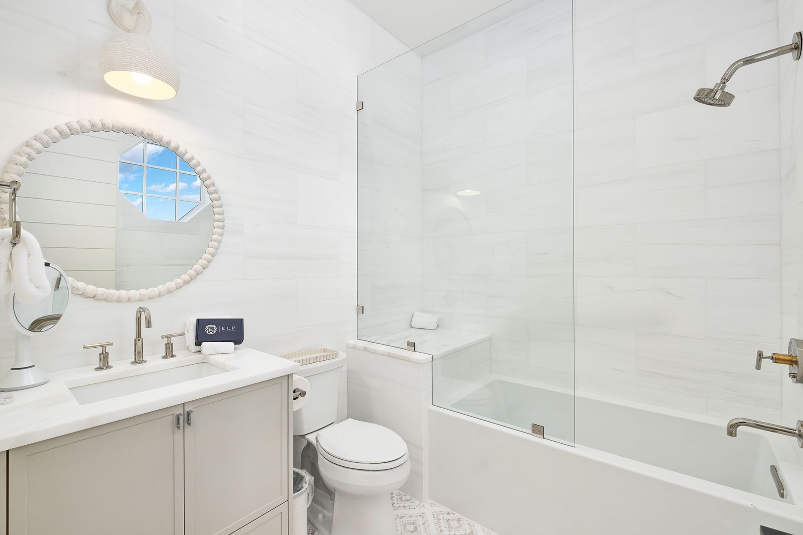 Step into your serene bathroom, where coastal elegance meets comfort. Enjoy the glass-enclosed tub-shower combo, decorative mirror, and spa-like finishes designed for your relaxation.