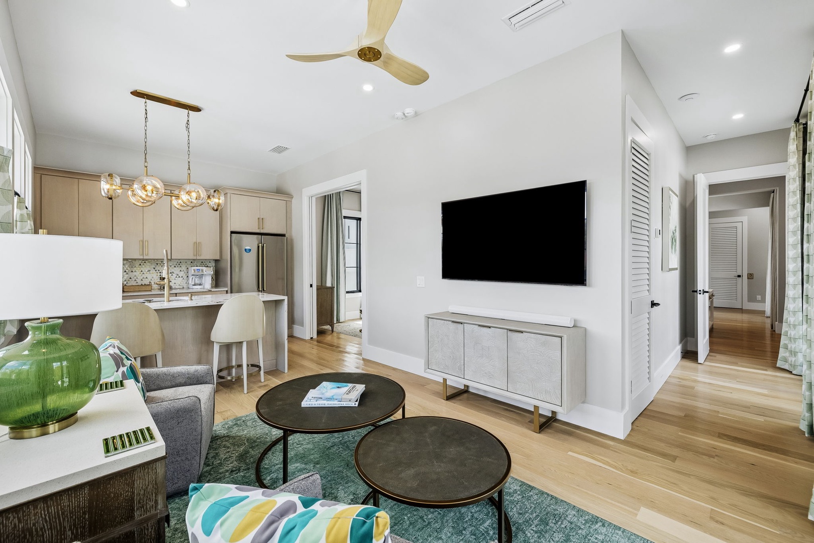 Settle into your bright, open living space where warm wood floors and vaulted ceilings create a spacious, airy feel. Unwind in the cozy seating area or gather around the stylish kitchen island.