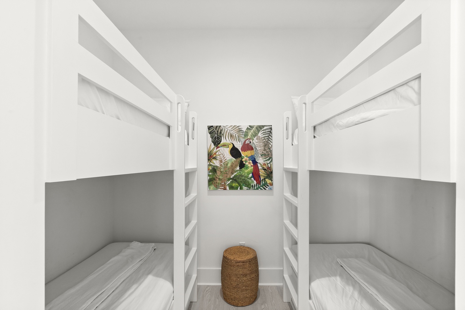 Cozy bunk room designed with crisp white walls and soft gray accents. Perfect for kids or extra guests, this space maximizes sleeping arrangements while keeping things simple and comfortable.