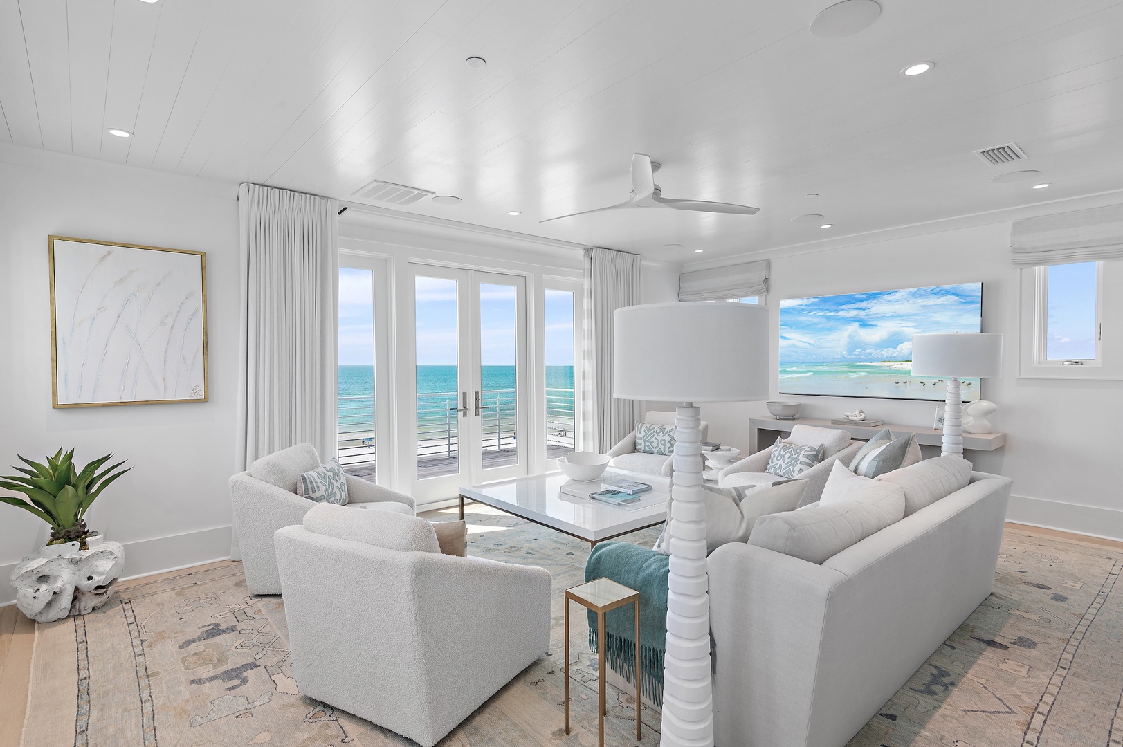 Sink into plush seating with stunning ocean views stretching across the horizon. Natural light fills your elegant coastal retreat, where soft furnishings and soothing tones create your perfect seaside sanctuary.