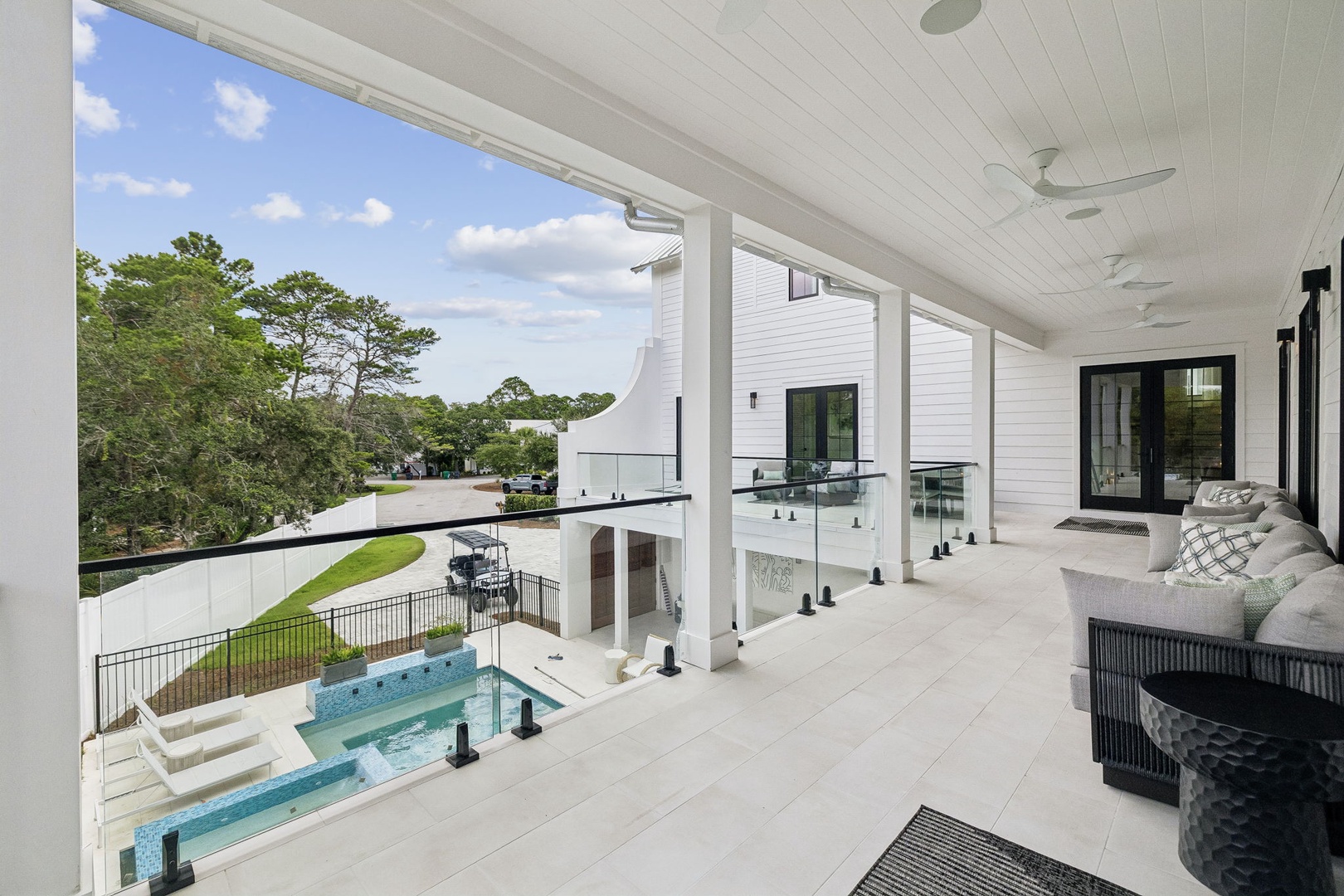 Relax on your covered upper balcony with stunning views of the pool, backyard, and natural surroundings—perfect for morning coffee or evening unwinding.