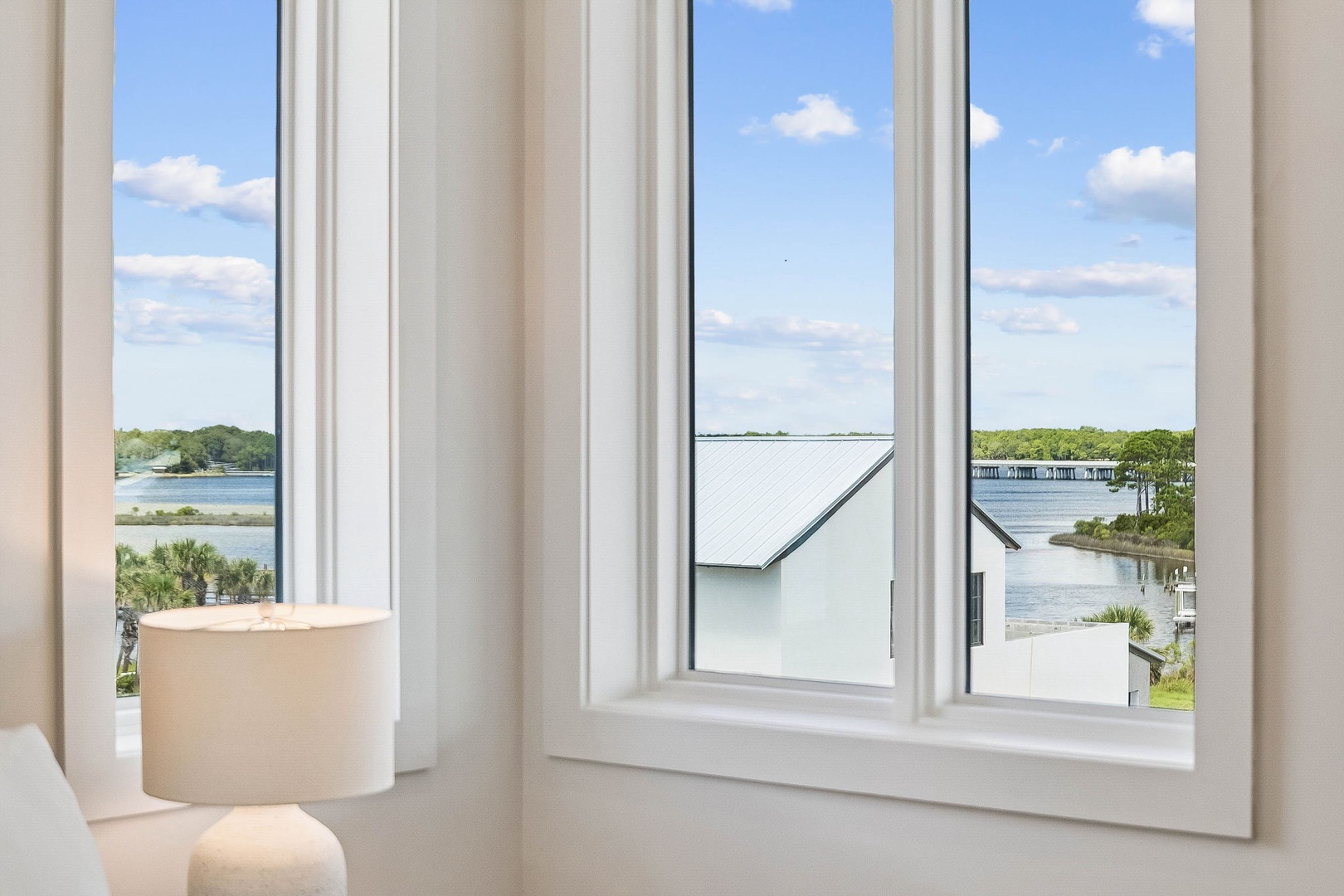 Wake up to stunning waterfront vistas framed by soft natural light. Watch the gentle tides and coastal greenery from your peaceful retreat—your perfect escape awaits.