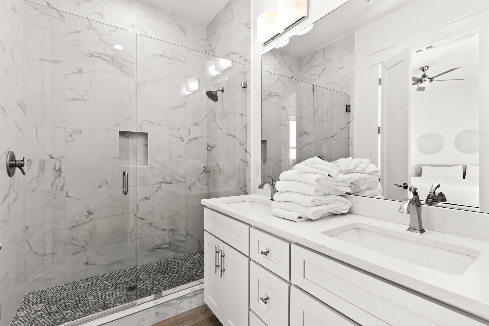 Step into your spa-like bathroom retreat, where luxurious marble surrounds you and plush towels await after a refreshing rain shower. This bright, elegant space sets the tone for your perfect getaway.