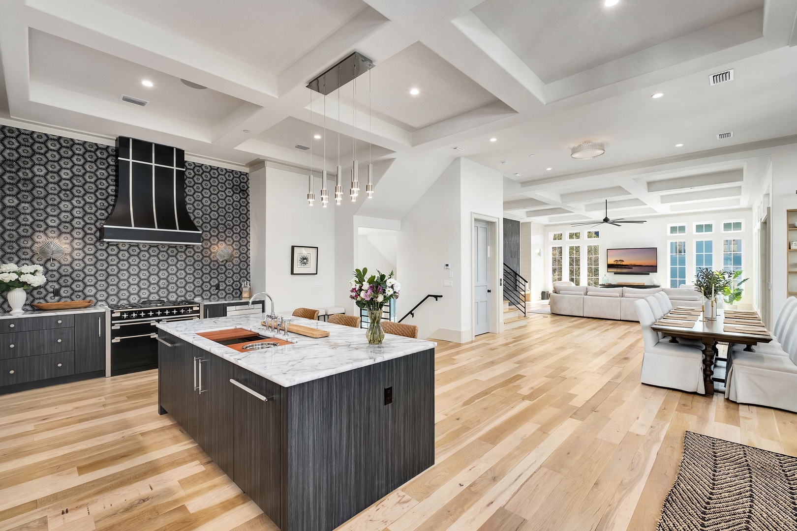 Step into your stunning open-concept kitchen where marble countertops and designer lighting create the perfect space for cooking and entertaining together.