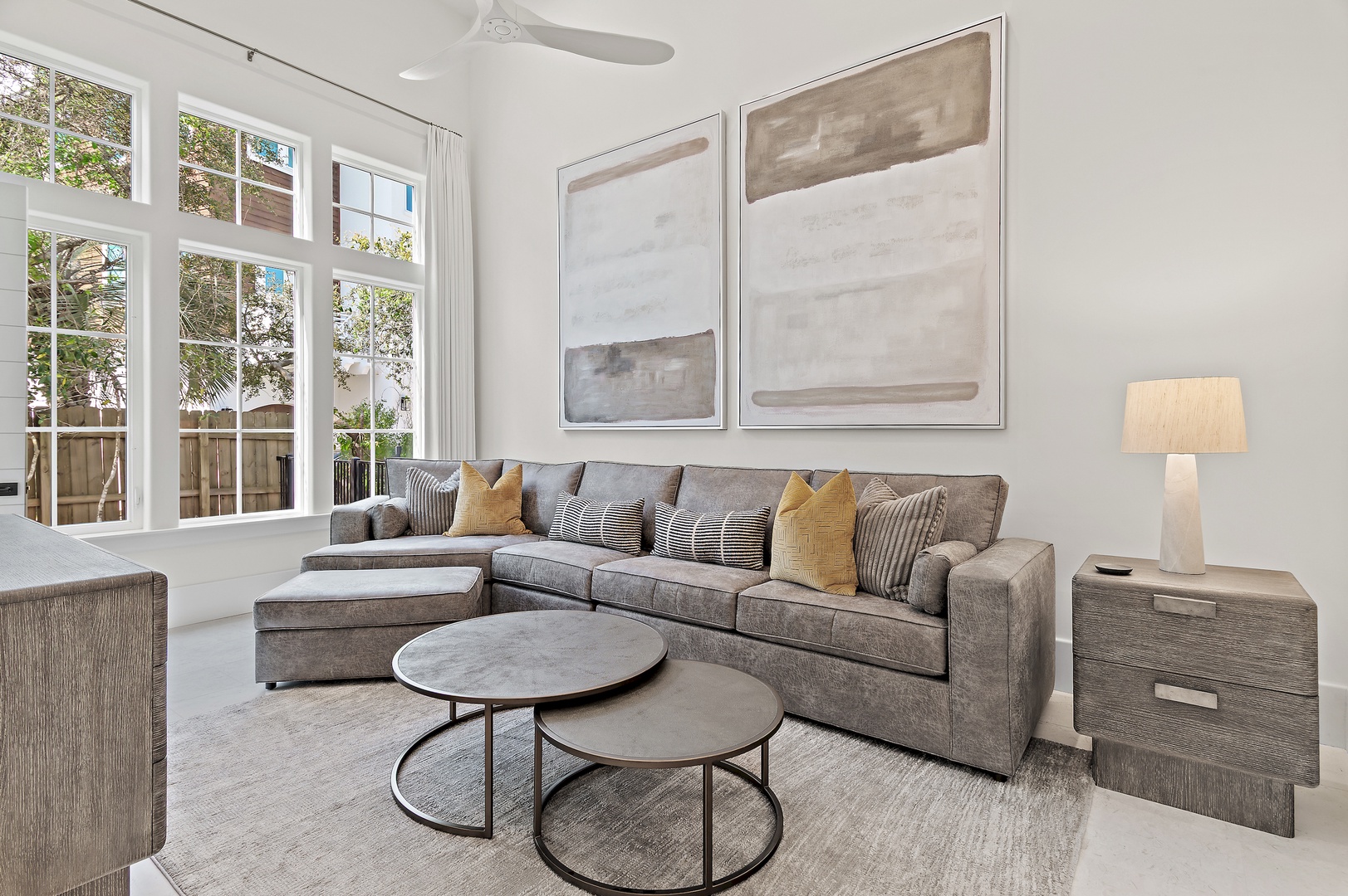 Sink into the plush sectional sofa and let the natural light streaming through the tall windows set a serene tone for your stay in this beautifully designed living space.