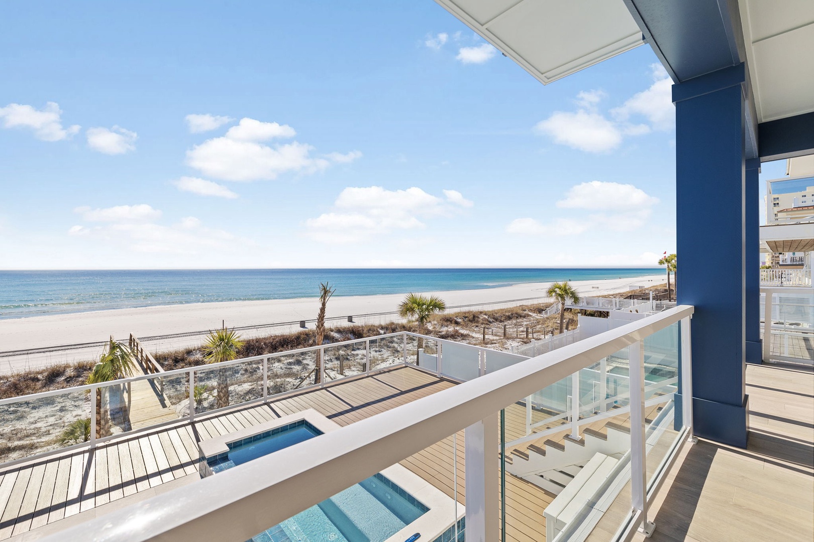 Expansive beachfront balcony with stunning ocean views, private pool, and direct beach access for the ultimate coastal getaway.