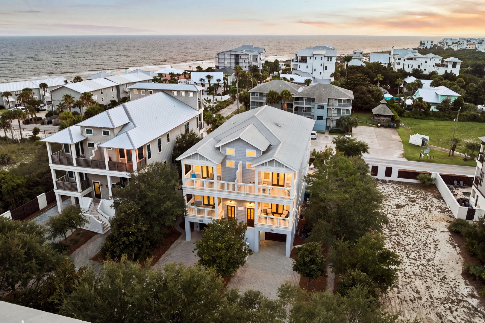 Beachfront property showcasing coastal architecture and natural surroundings, with the Gulf of Mexico stretching endlessly along the horizon at sunset.