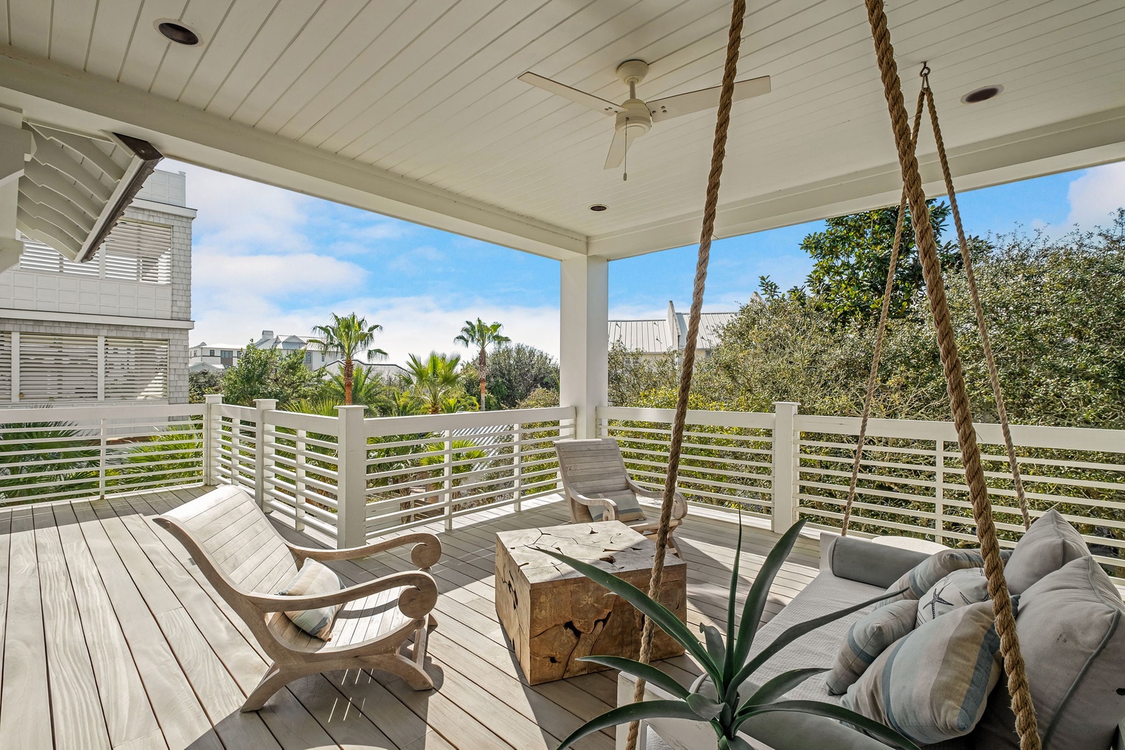 Sway gently in your private porch swing while soaking up tropical views and ocean breezes from this stunning covered deck.
