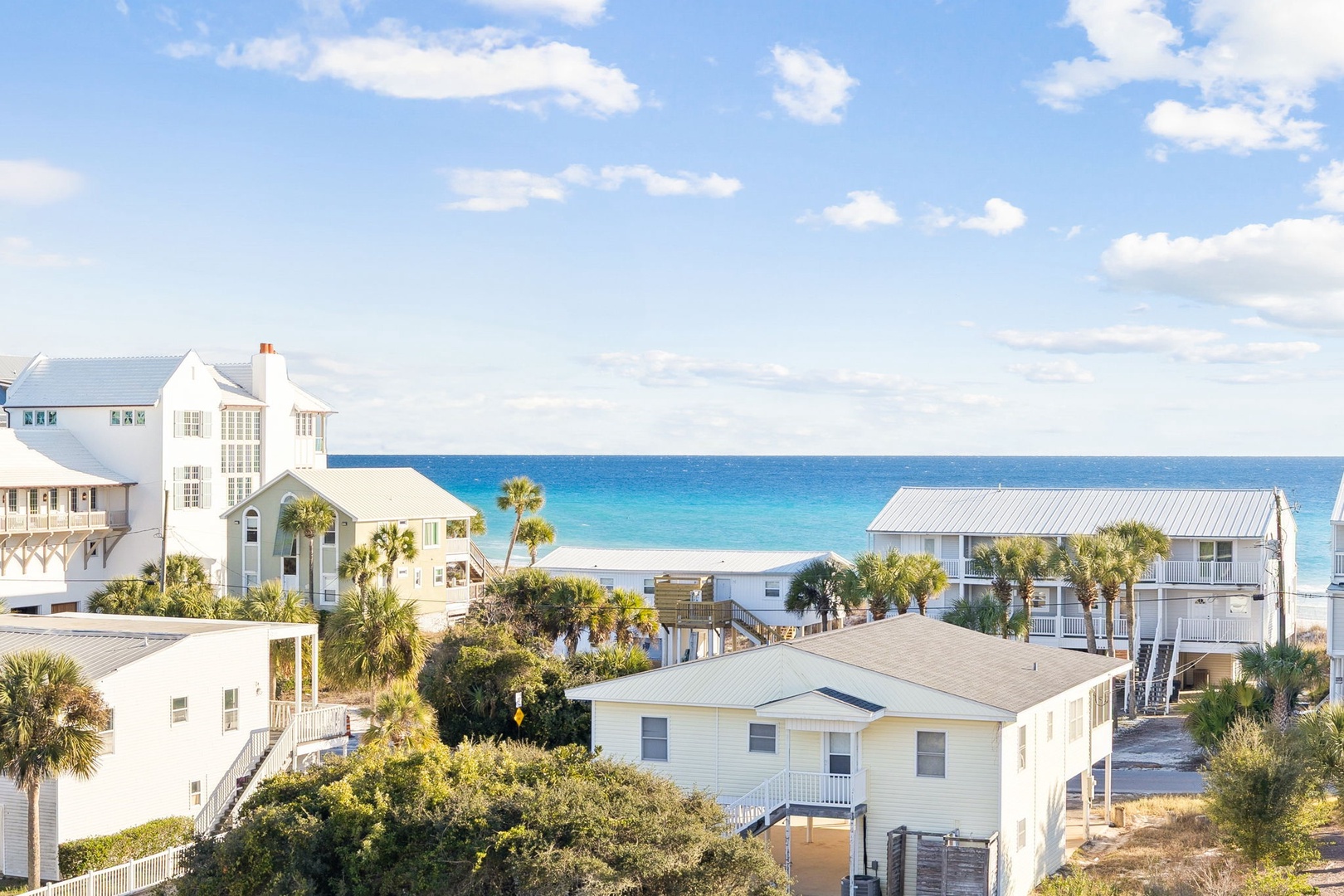 Charming coastal community with stunning white sand beaches and turquoise waters just steps away from comfortable vacation homes.
