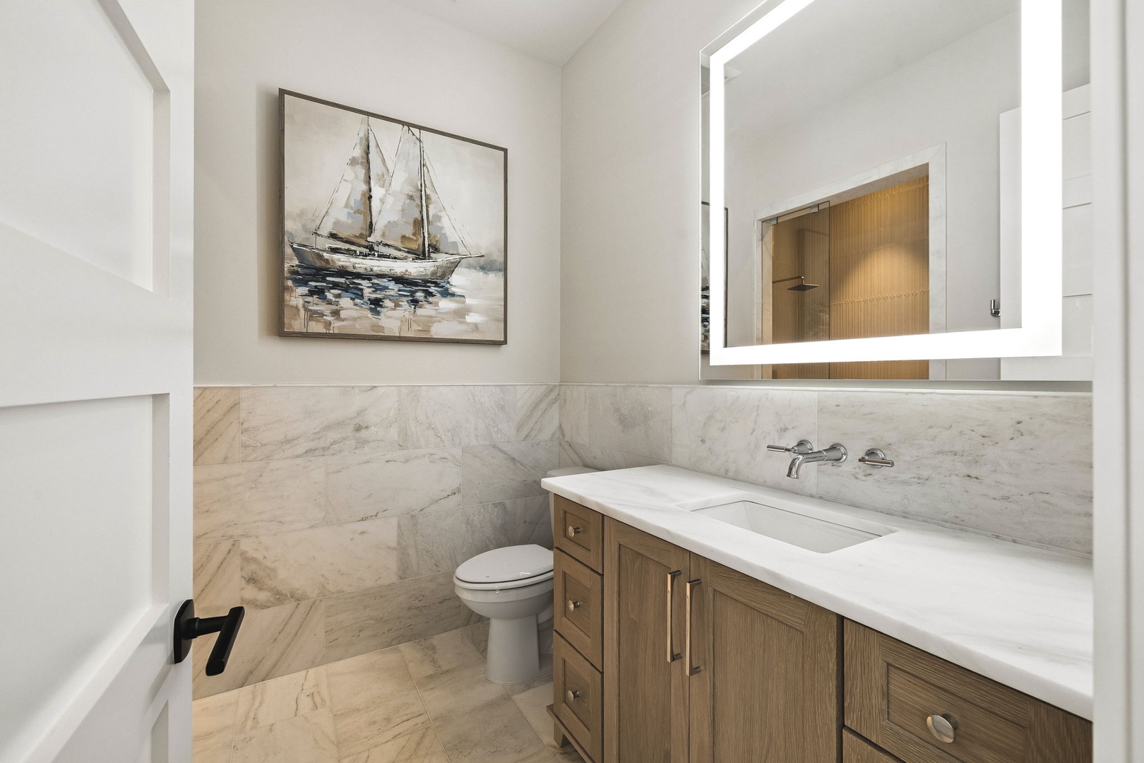 Step into a coastal-inspired bathroom with warm wood tones, elegant marble details, and soft lighting that makes your morning routine feel like a spa experience.