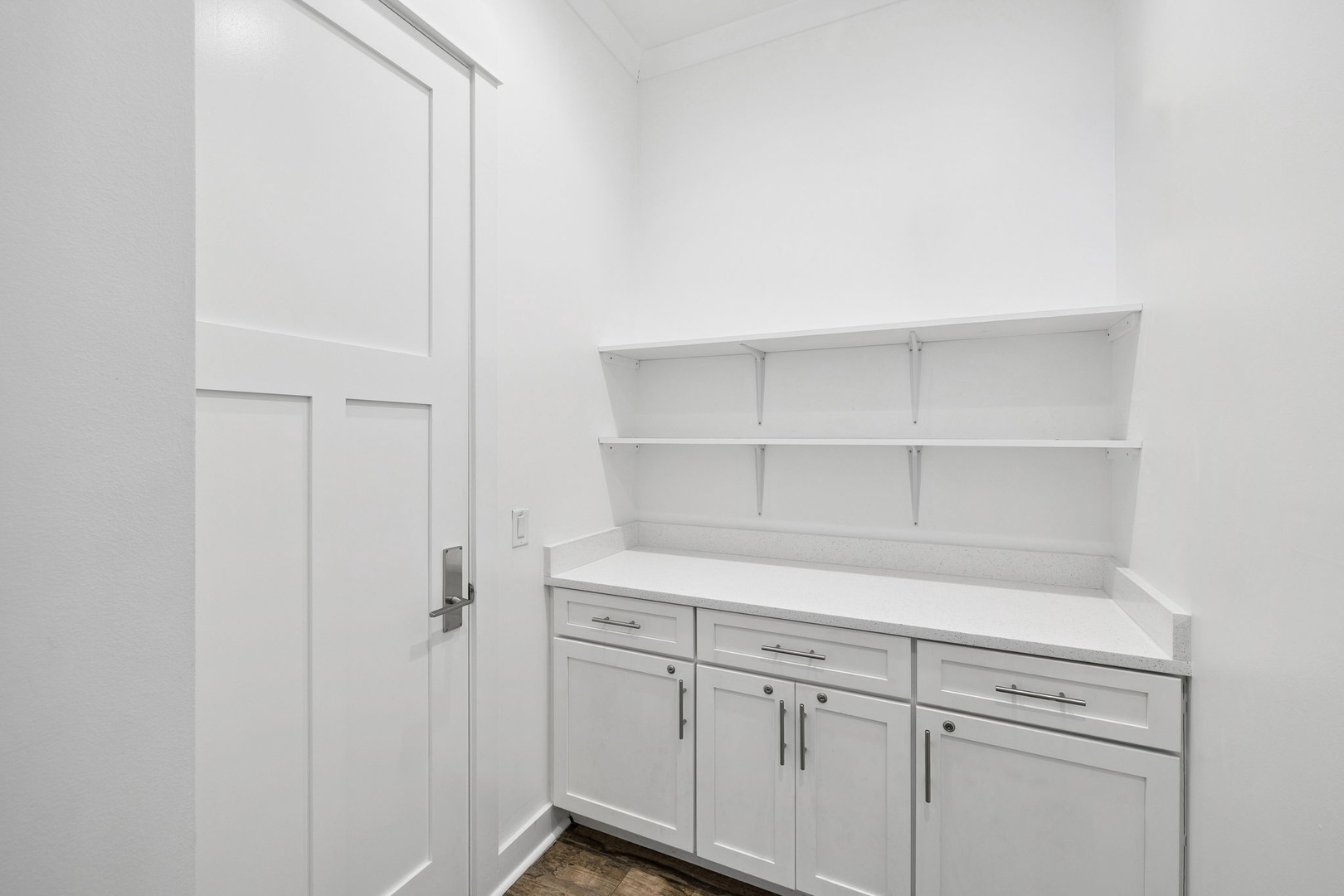 Your private pantry offers abundant storage with sleek white cabinetry and open shelving for easy organization.