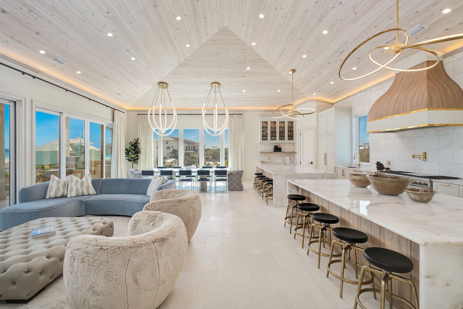 Gather together in this stunning open-concept space where soaring cathedral ceilings meet coastal elegance. Sink into plush seating while you chat, cook, and dine with loved ones in your bright, airy retreat.