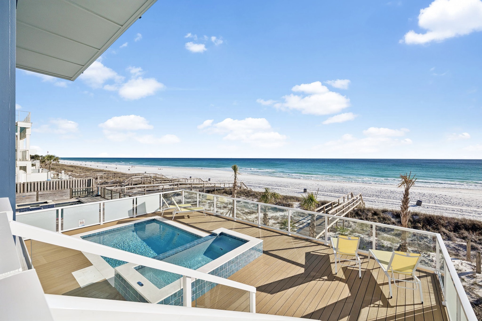 Soak up endless ocean views from your private deck with hot tub, just steps from pristine white sand beaches.