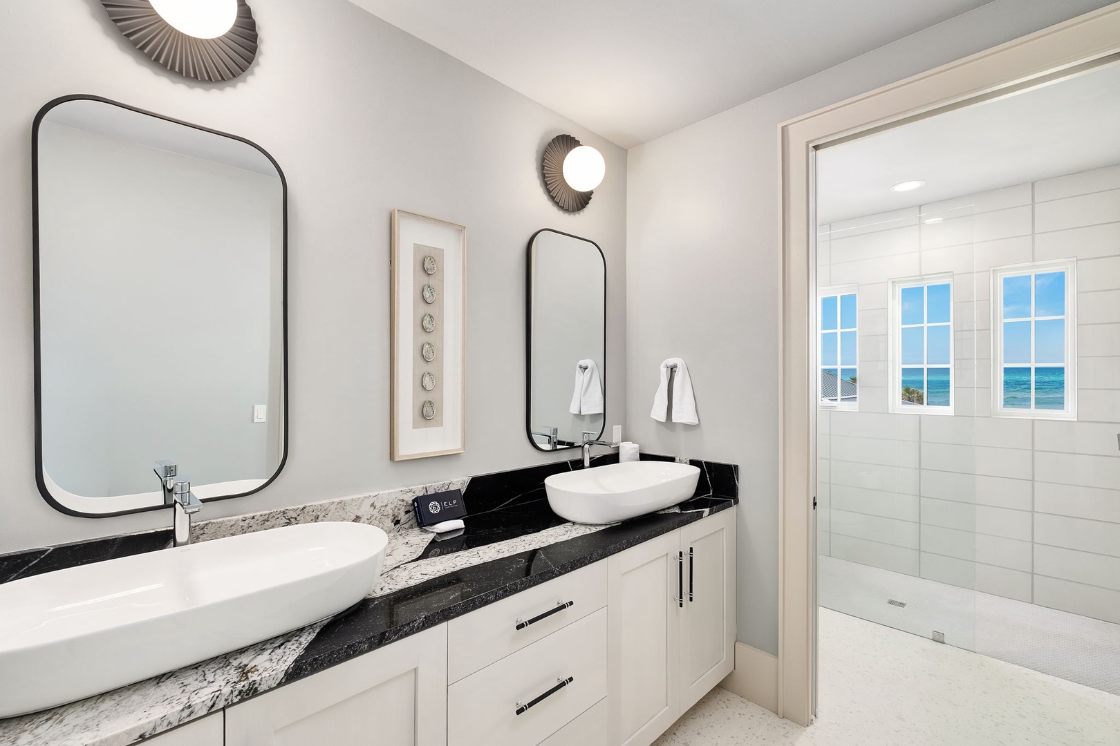 Unwind in your elegant bathroom with dual vanities, granite counters, and a spacious glass shower—all with stunning sea views.
