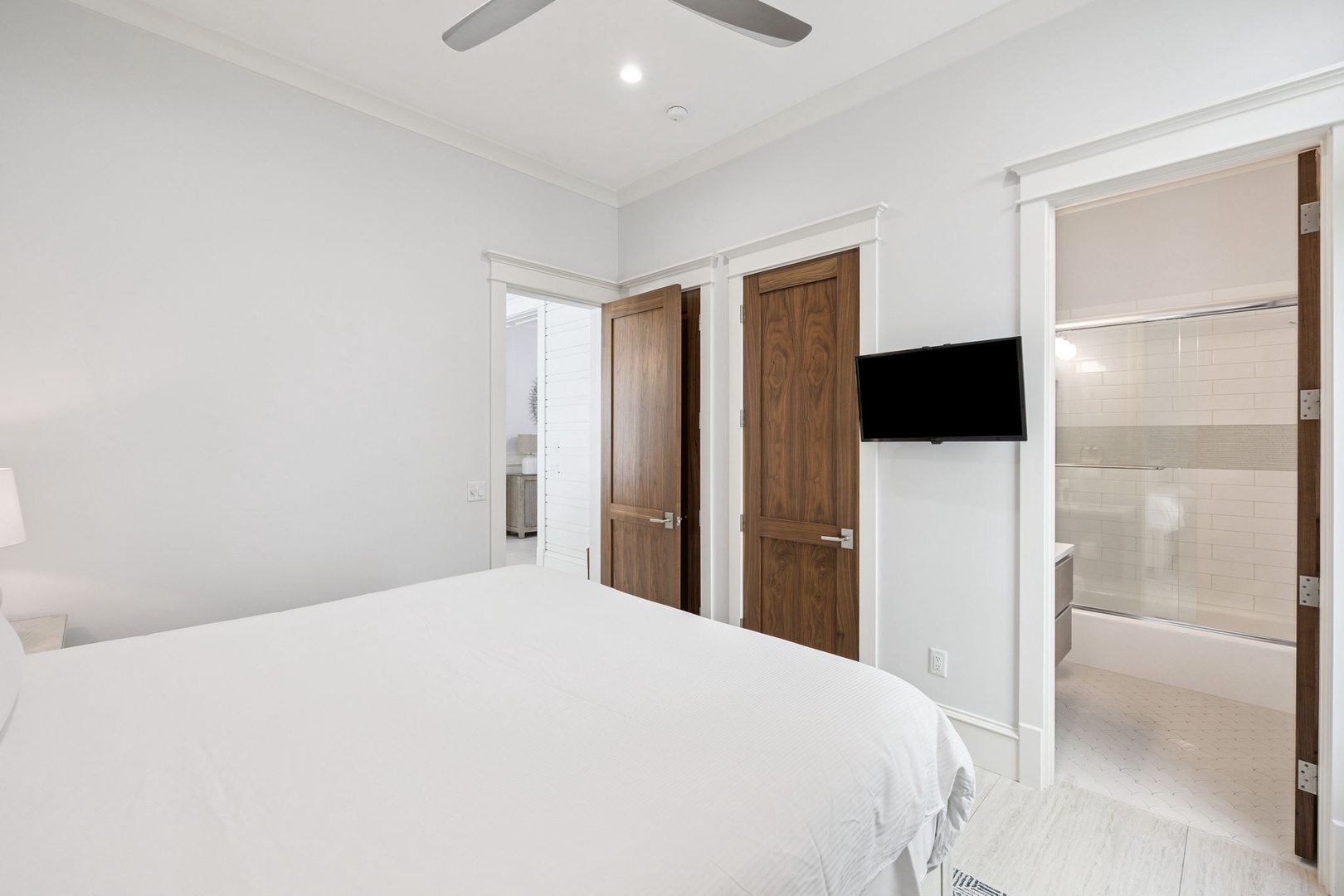 Drift off in your serene white bedroom with ceiling fan comfort and private ensuite just steps away.
