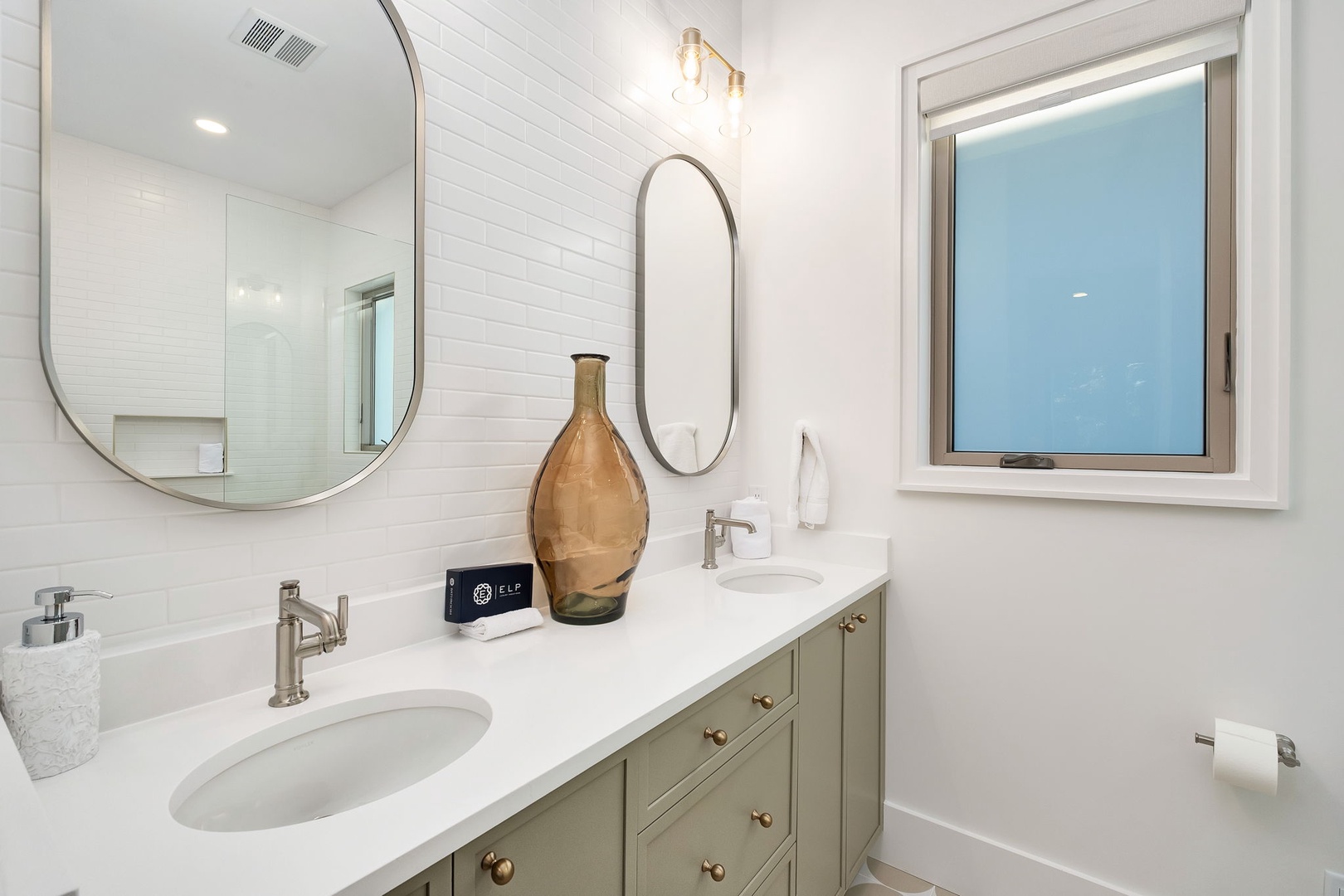 Step into your spa-like bathroom with dual vanities, gleaming quartz countertops, and thoughtful touches that make your morning routine feel luxurious.