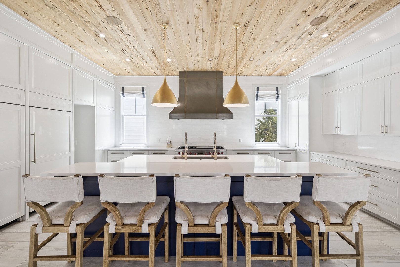 Your gourmet kitchen awaits with stunning wood ceiling, spacious island seating, and premium appliances for memorable cooking experiences together.