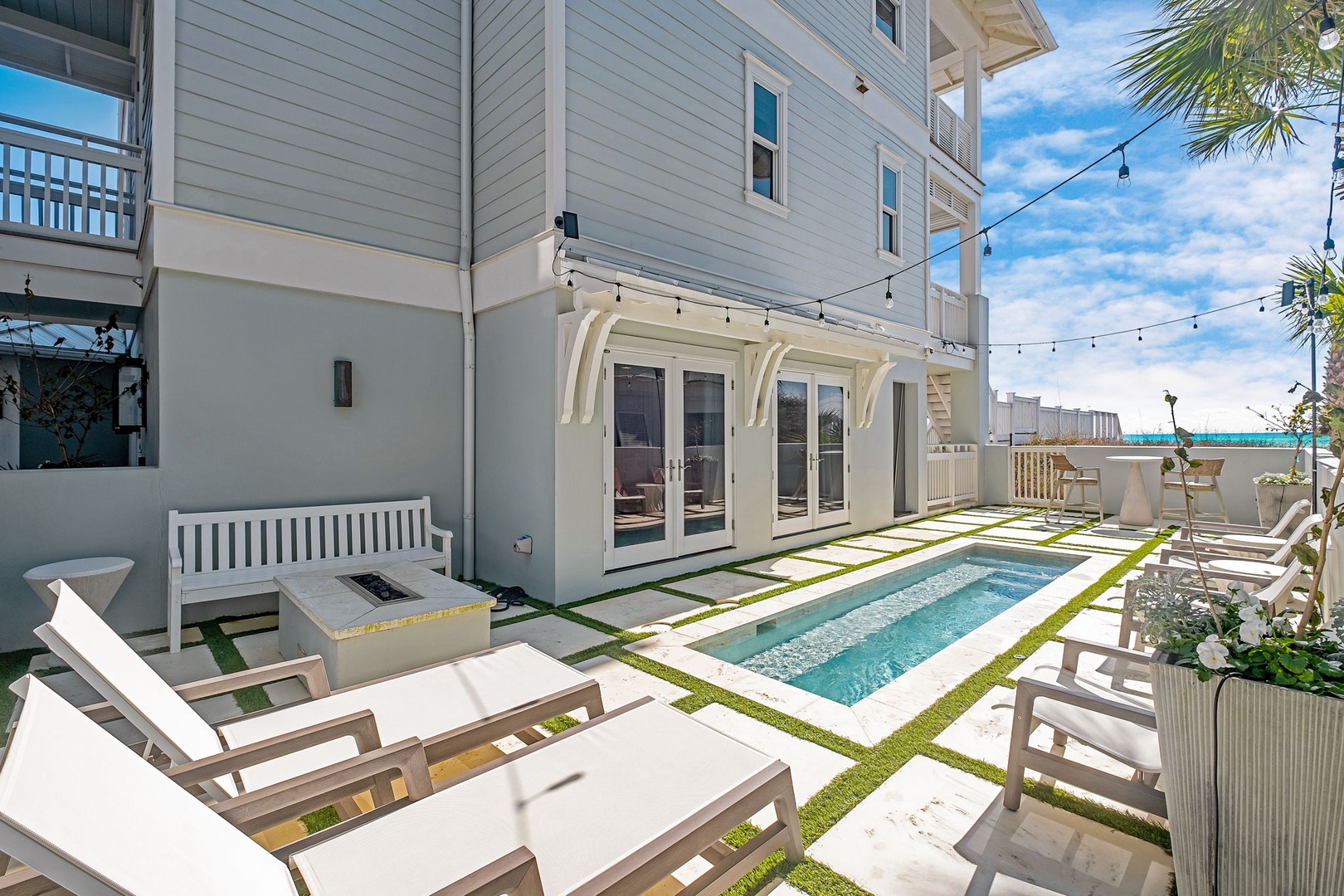 Your private courtyard awaits with a sparkling plunge pool, pristine loungers, and inviting seating perfect for soaking up sunshine or unwinding under twinkling lights after a memorable day.
